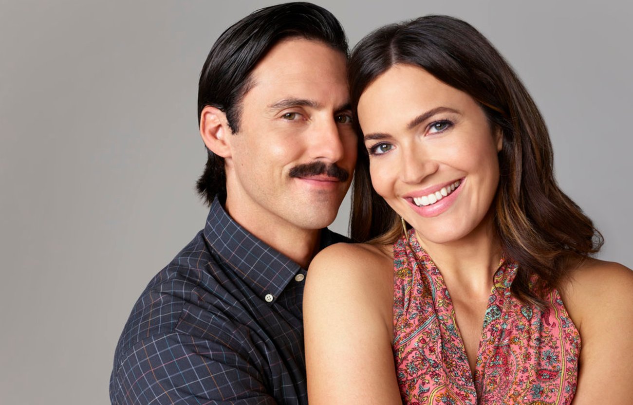 This is Us Season 6 stars  Milo Ventimiglia and Mandy Moore smile while holding each other lovingly.