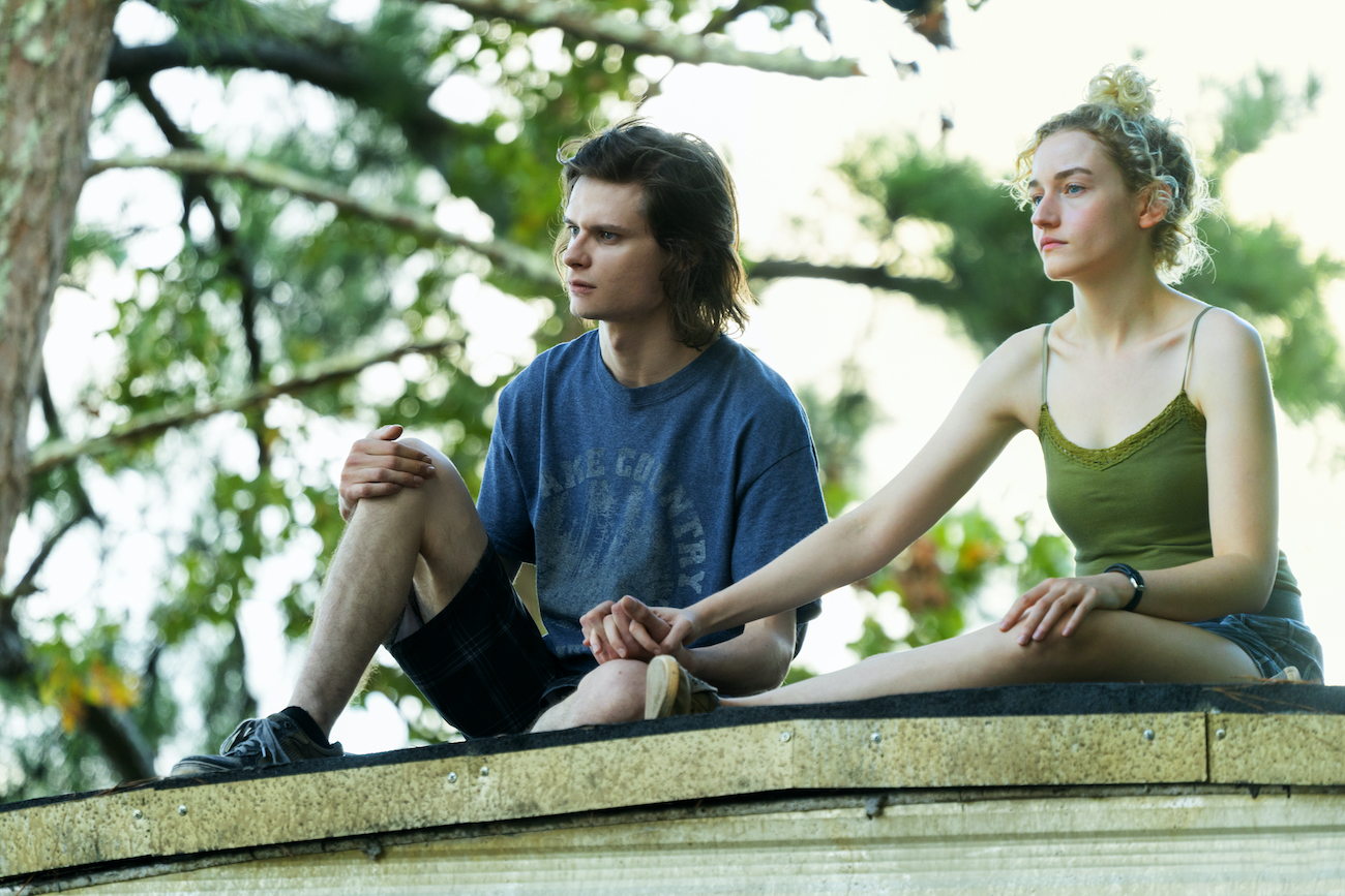 Wyatt (Charlie Tahan) holds Ruth's (Julia Garner) hand on top of his trailer in the final season of 'Ozark'