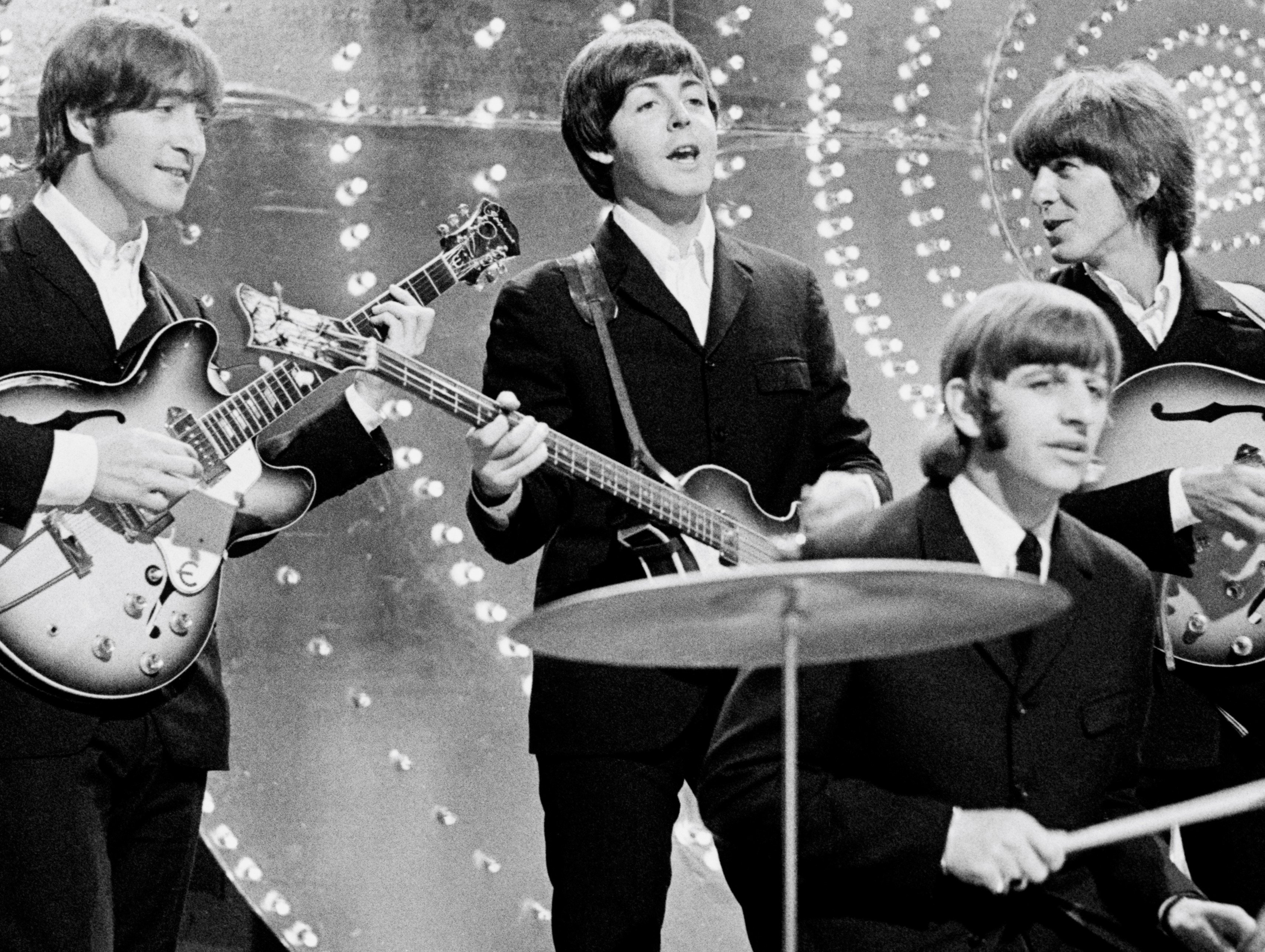 The Beatles John Lennon, Paul McCartney, Ringo Starr, and George Harrison playing songs