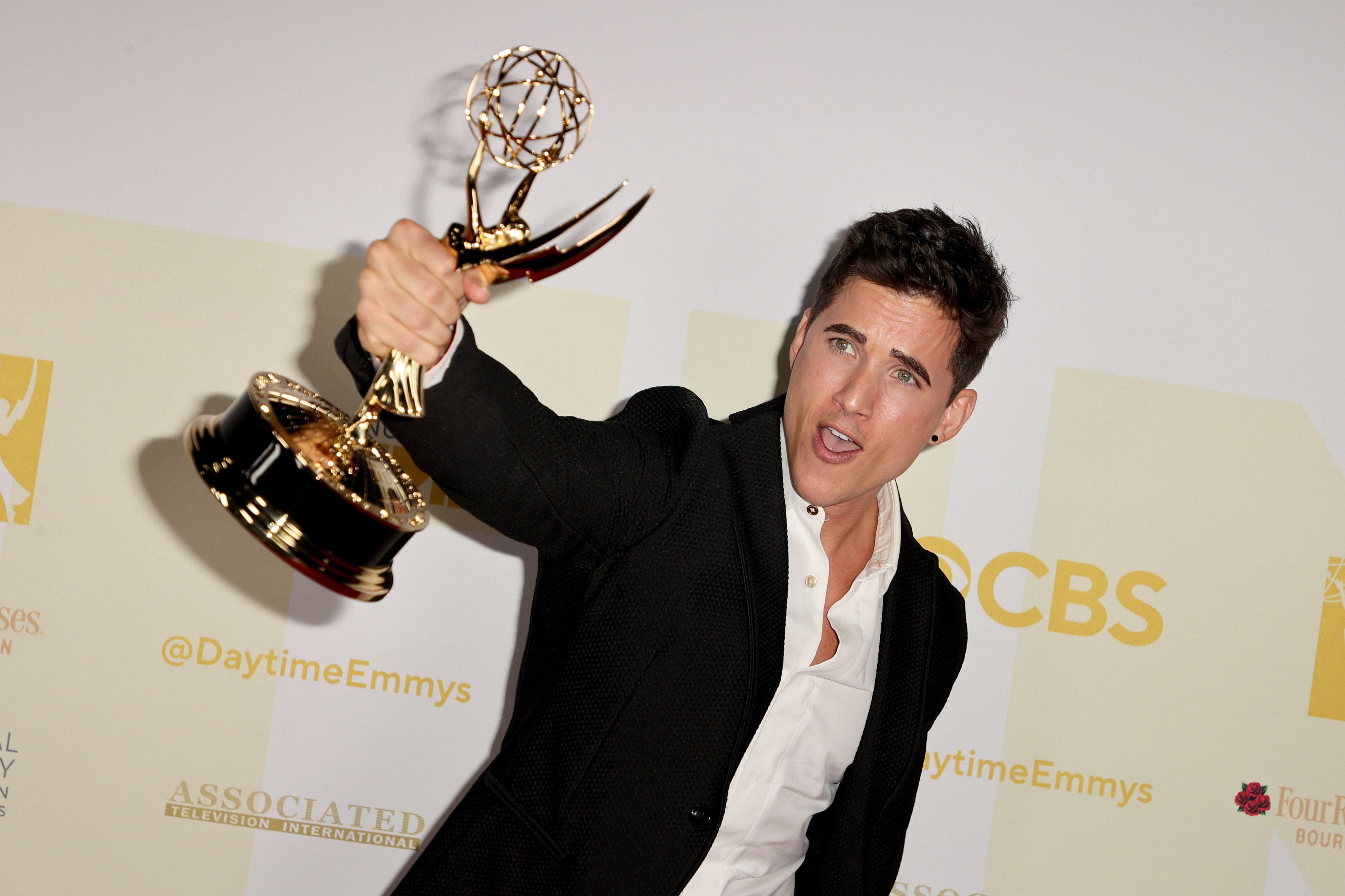 Actor Mike Manning holds up a Daytime Emmy award.
