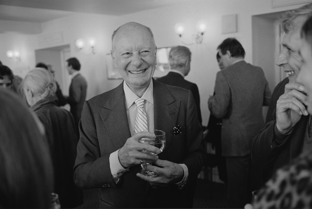 English actor John Gielgud with a glass of wine celebrating his 80th birthday
