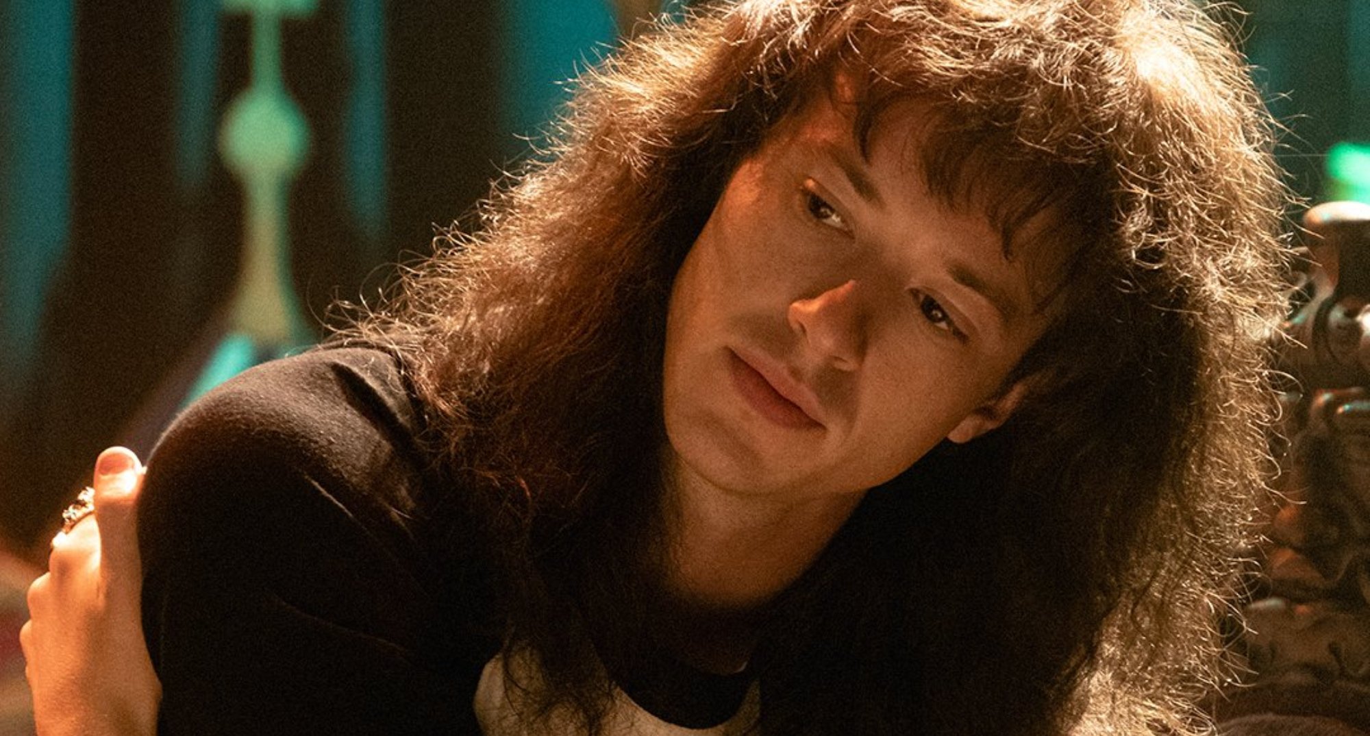 Actor Joseph Quinn as metalhead Eddie Munson in 'Stranger Things' Season 4 wearing Hellfire shirt.