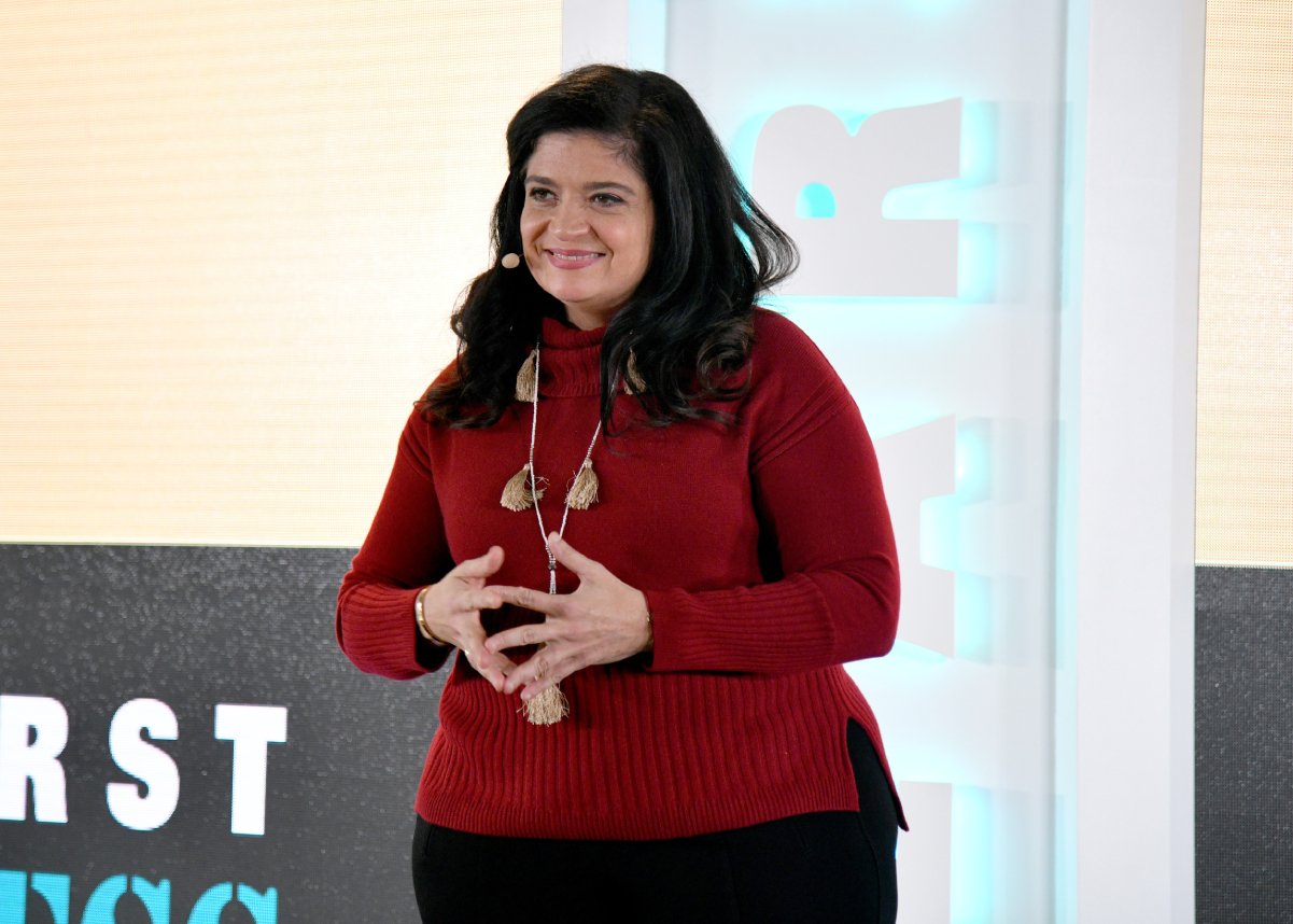 Celebrity chef Alex Guarnaschelli wears a red sweater in this photograph.