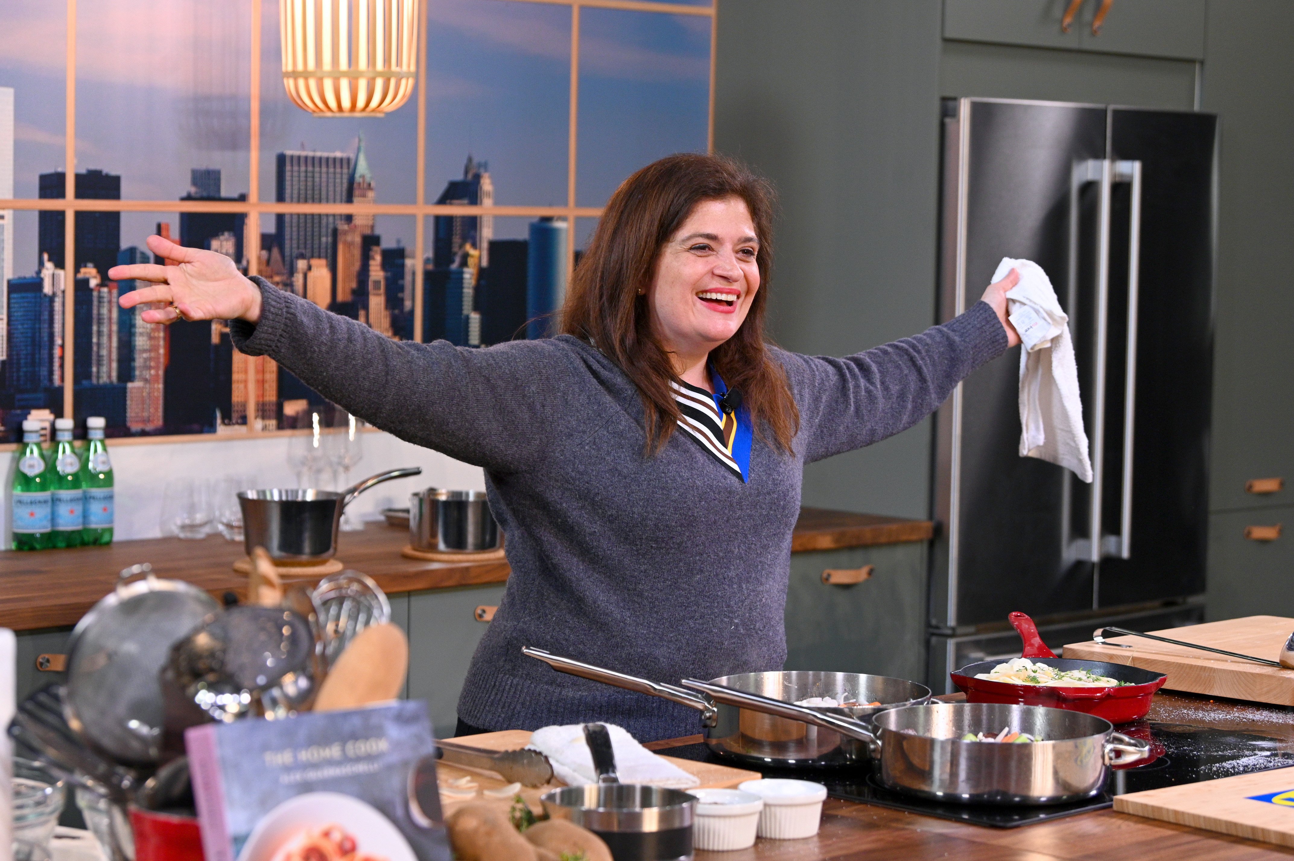 Celebrity chef Alex Guarnaschelli wears a blue v-necked sweater in this photograph.