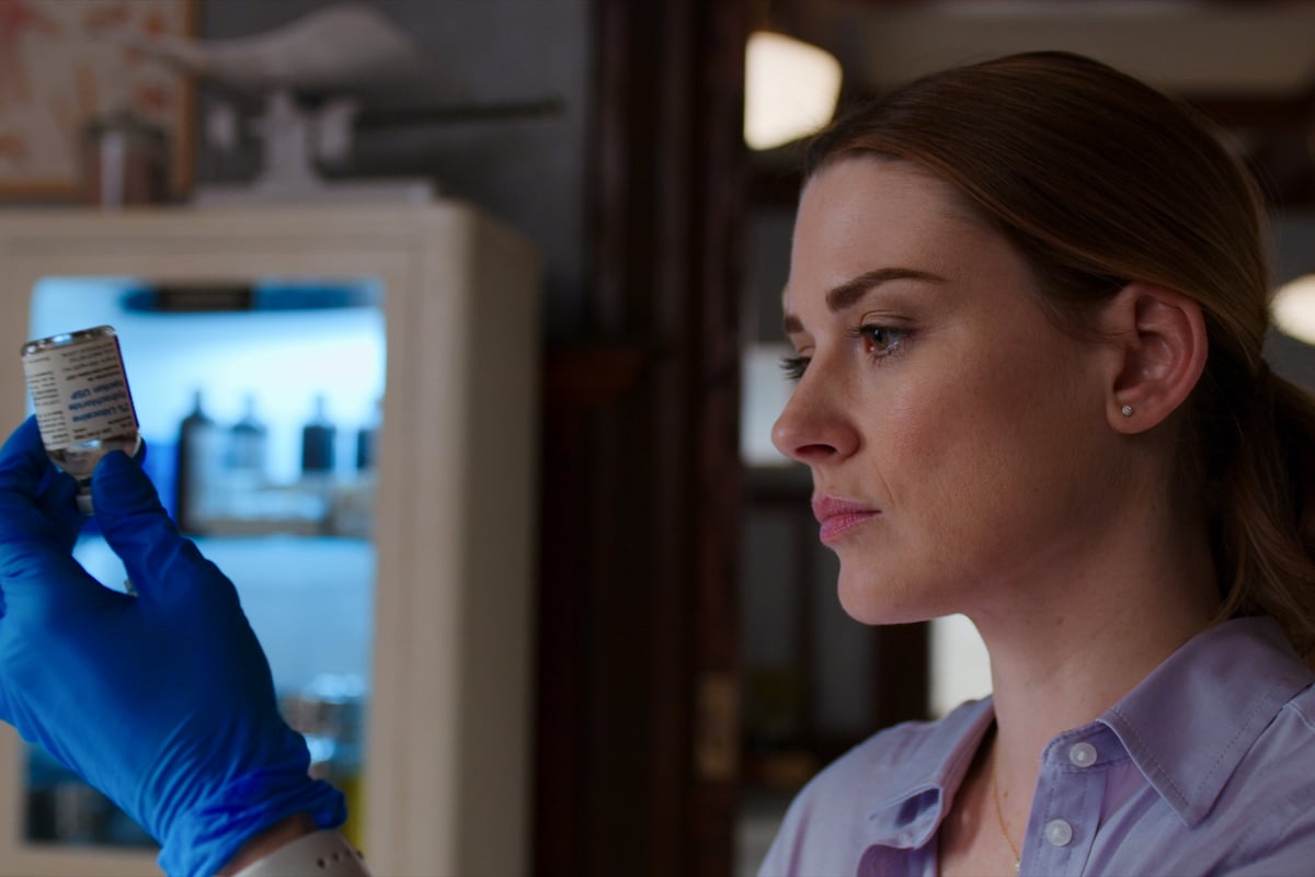 Alexandra Breckenridge as Melinda Monroe holding some medicine in her gloved hand on 'Virgin River'