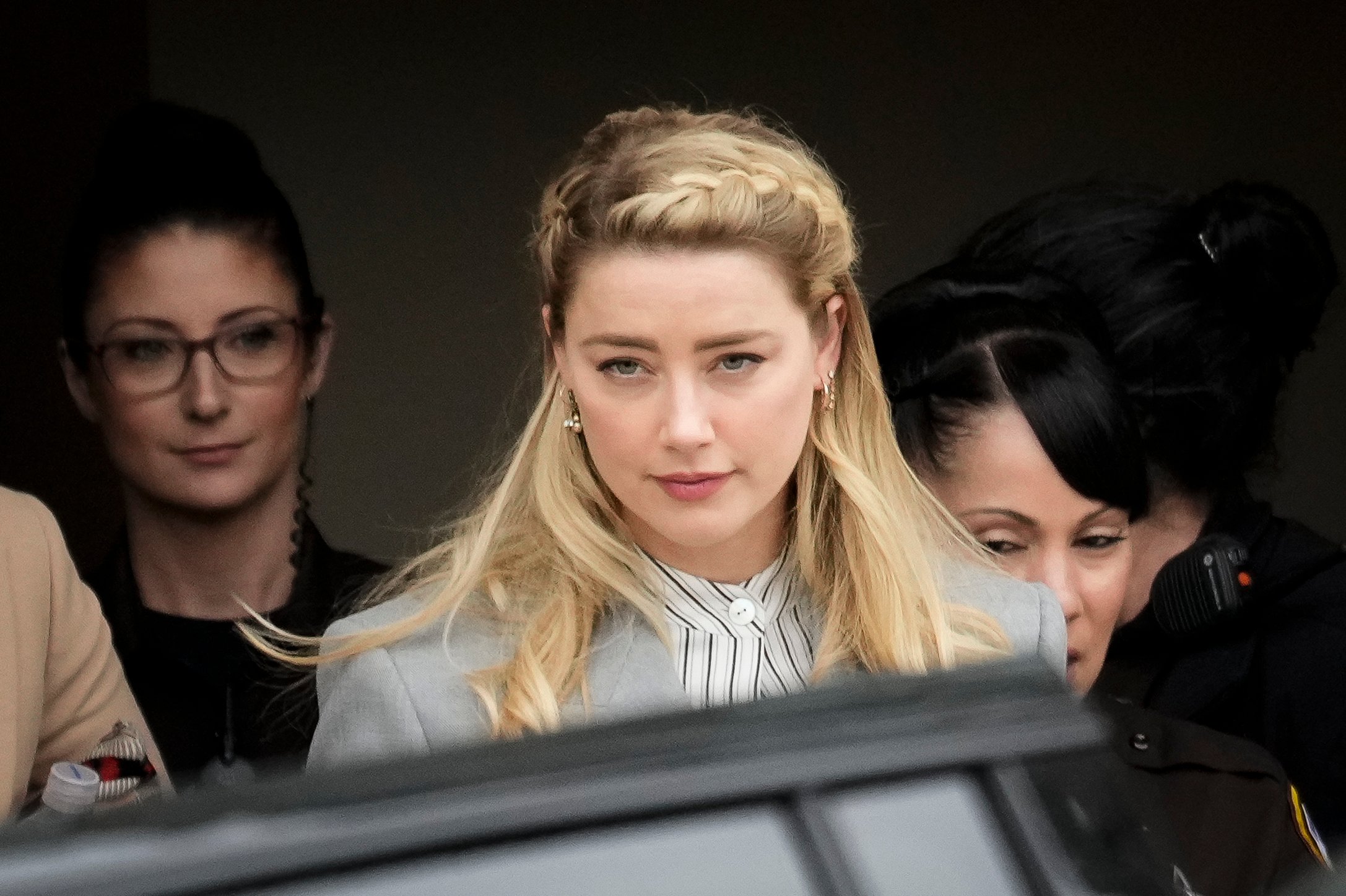 Amber Heard, seen here wearing a gray suit, issued a statement regarding the verdict of her trial against ex-husband Johnny Depp.