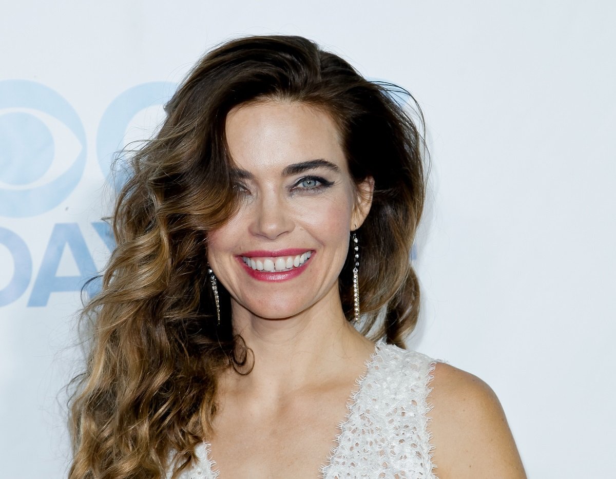 'The Young and the Restless' actor Amelia Heinle wearing a white dress during a red carpet appearance.