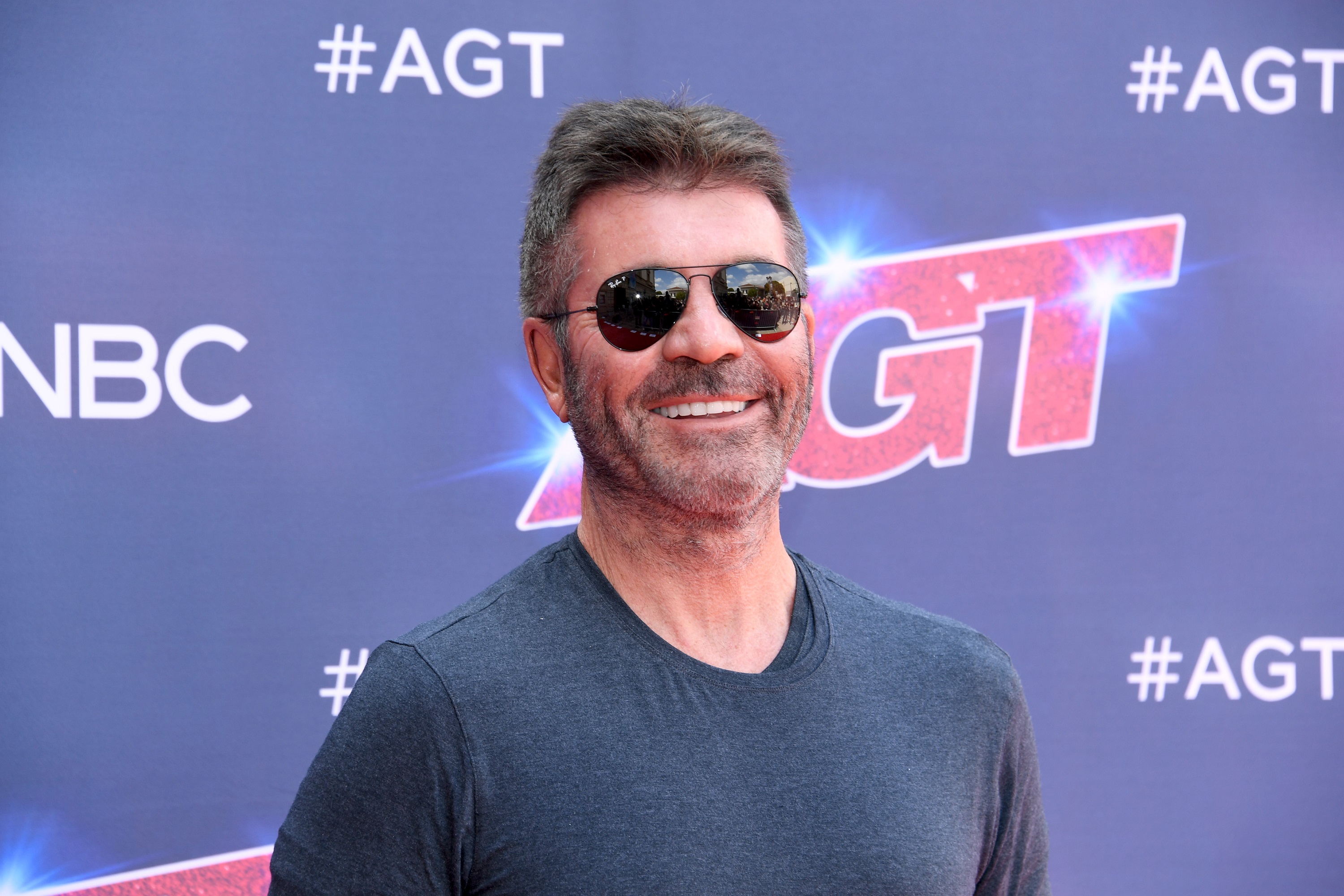 'America's Got Talent' Season 17 judge Simon Cowell smiles for photographers