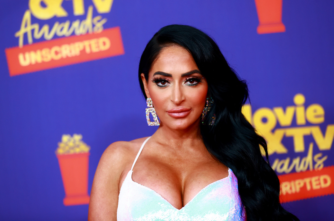 Angelina Pivarnick poses on a red carpet in a gown.