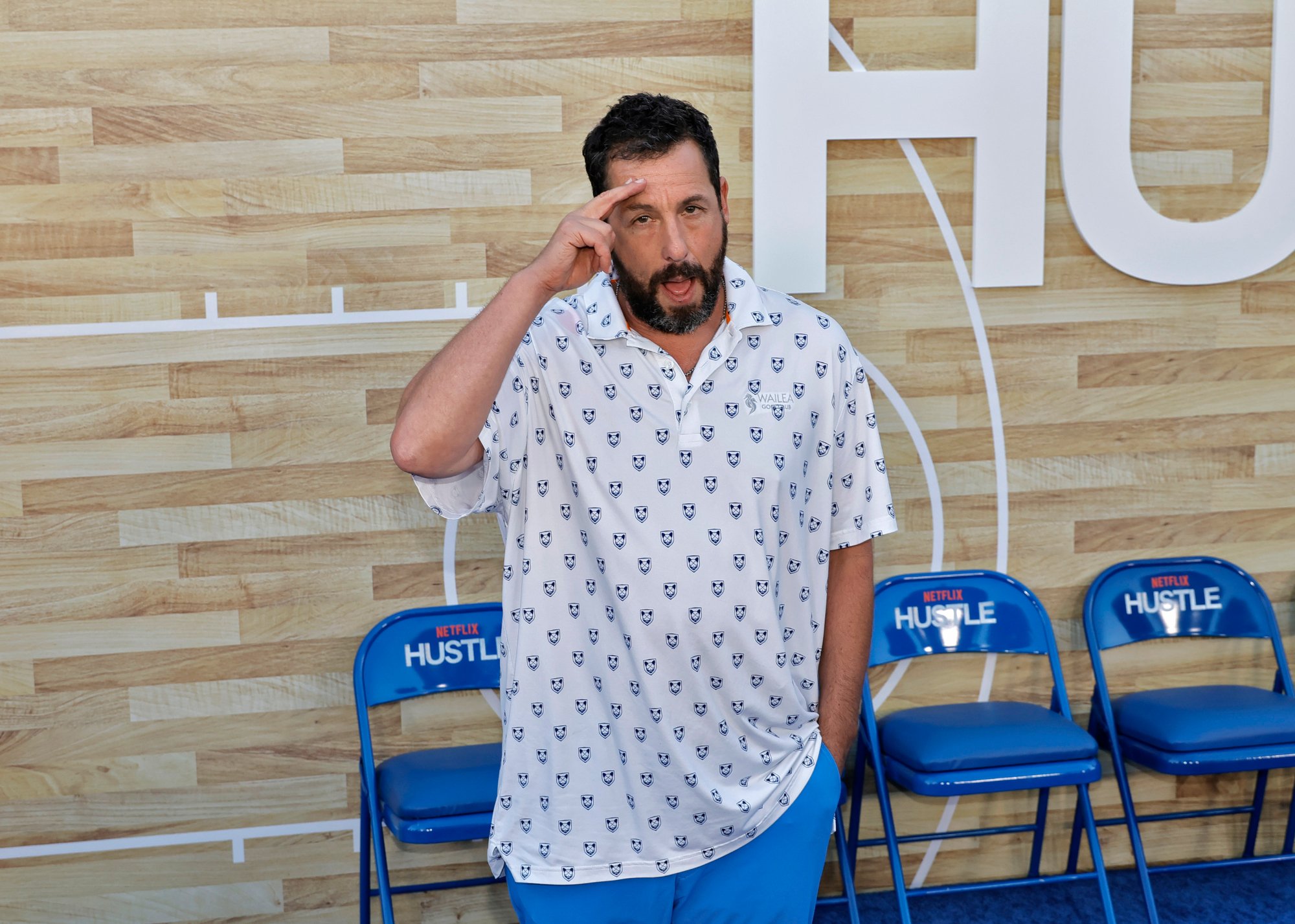 'Anger Management' actor Adam Sandler saluting and sticking his tongue out with his hand in his pocket