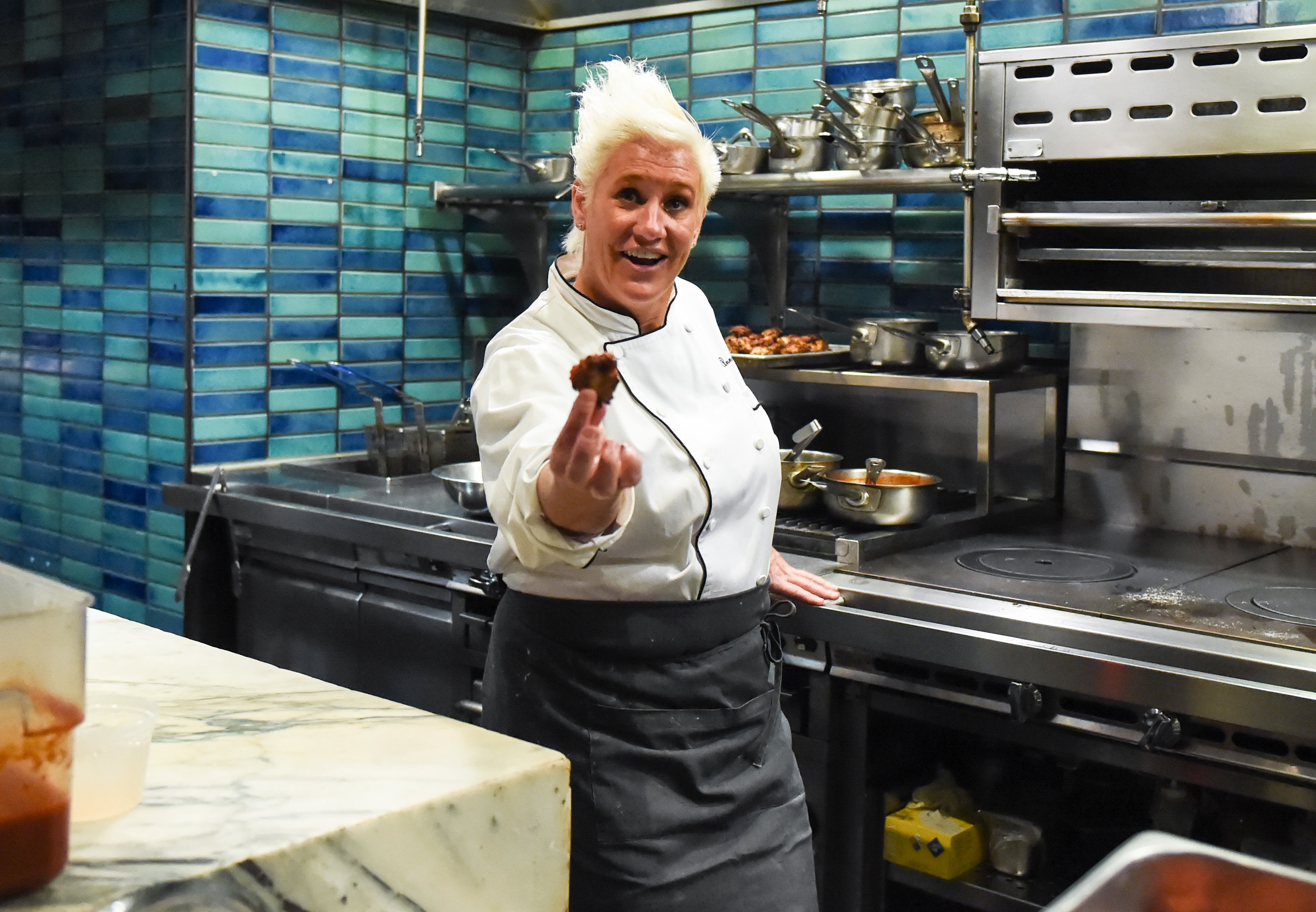 Celebrity chef Anne Burrell wears her chef's jacket in this photo.