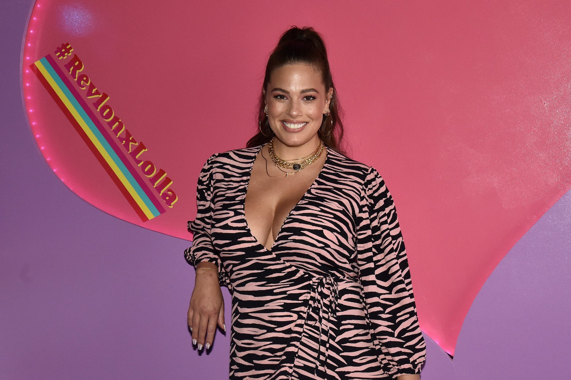 Ashley Graham poses in a leopard print dress.