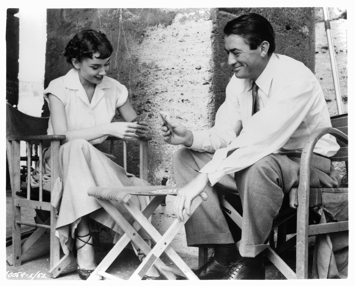 Audrey Hepburn plays cards with Gregory Peck in a scene from Roman Holiday in 1953