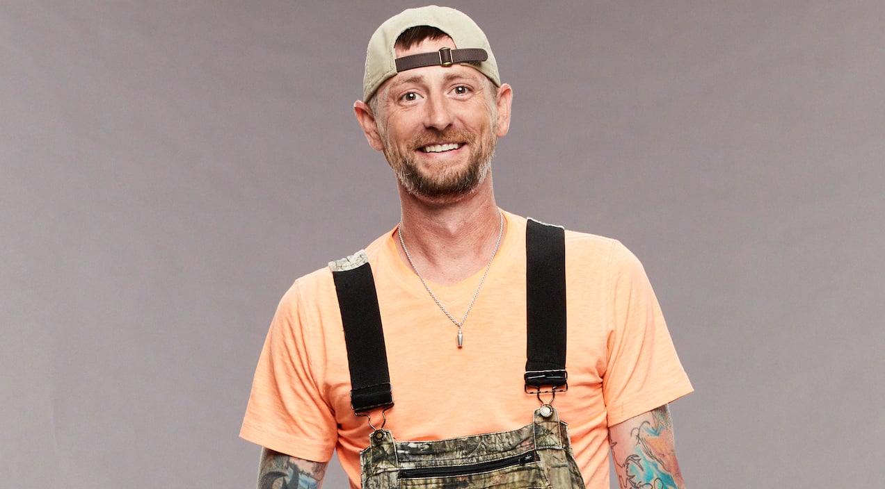 Brandon Frenchie French on 'Big Brother 23' stands in overalls and an orange shirt.