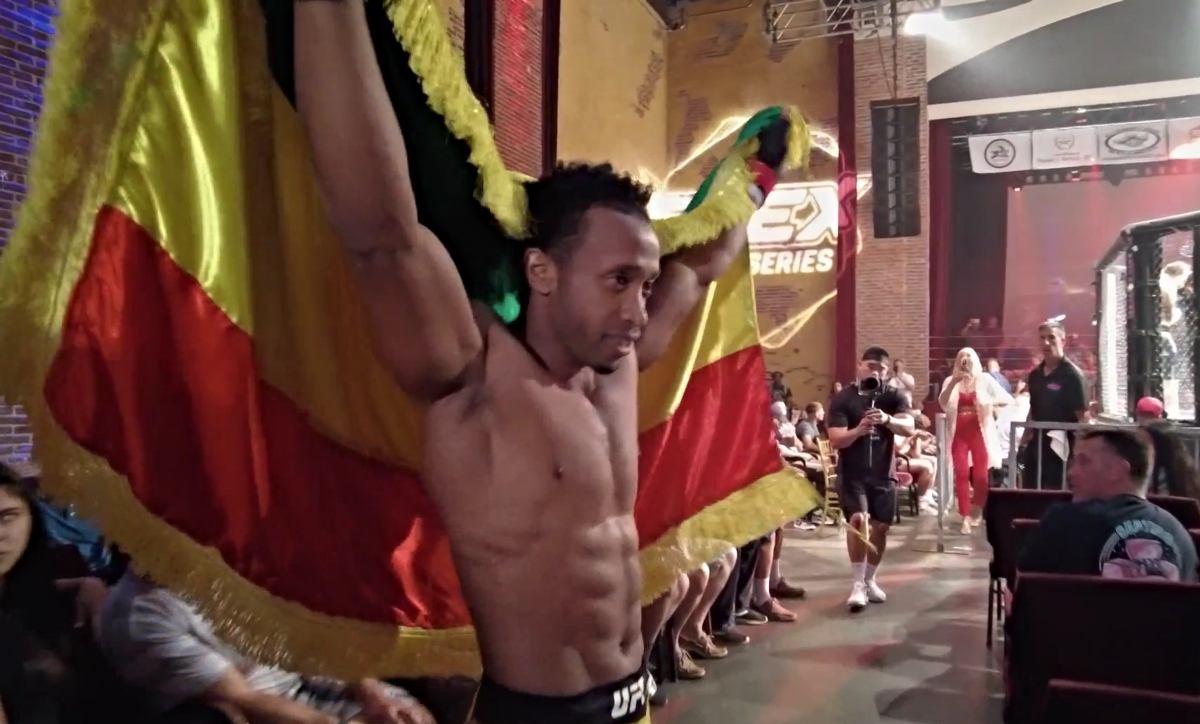 Biniyam Shibre walking into his MMA fight in New York, holding an Ethiopian flag on '90 Day Fiancé.'