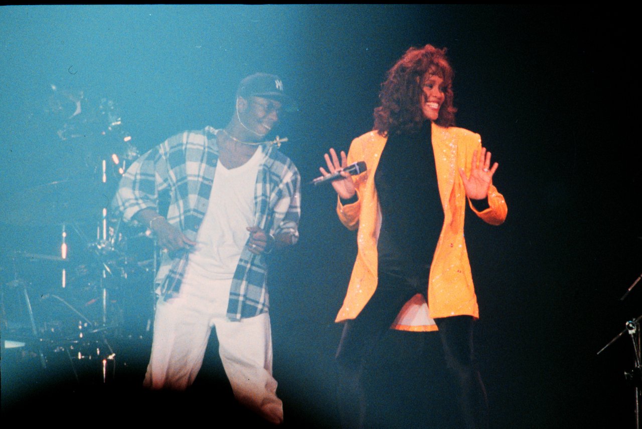 Bobby Brown and Whitney Houston on stage; Brown says Houston made the first move on him in their relationship