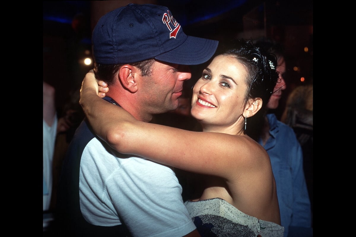 Then-married couple Bruce Willis and Demi Moore put their arms around each other in 1994