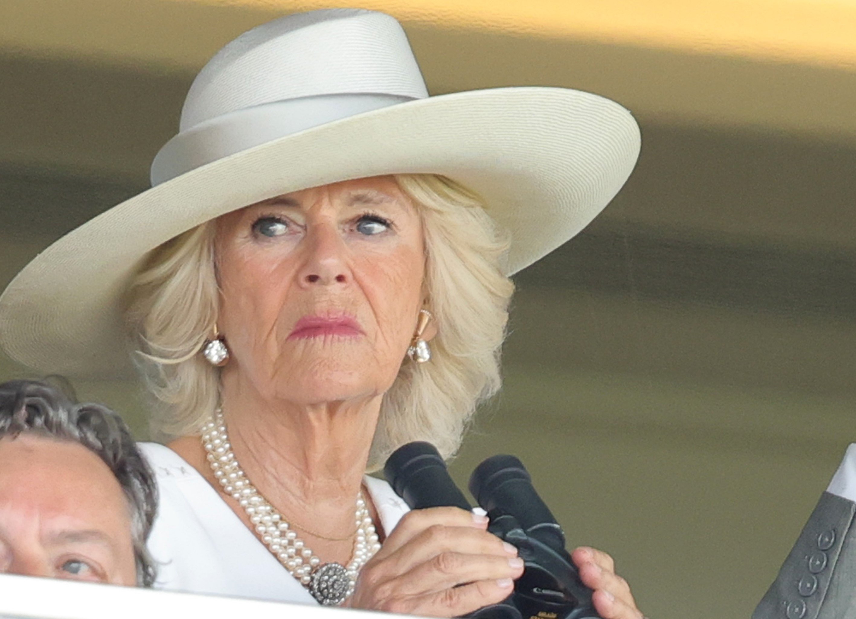 Camilla Parker Bowles holding binoculars at the Royal Ascot