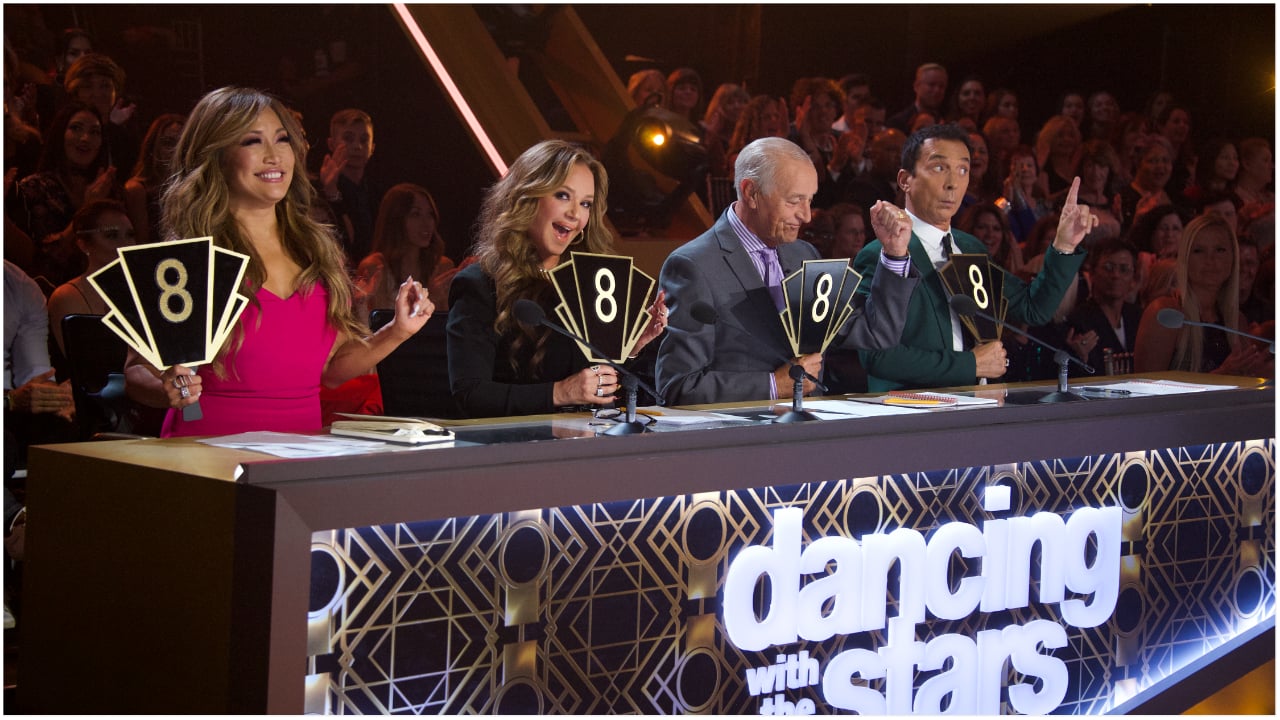 Carrie Ann Inaba, Leah Remini, Len Goodman, and Bruno Tonioli holding up scores at the judging panel of 'Dancing with the Stars'