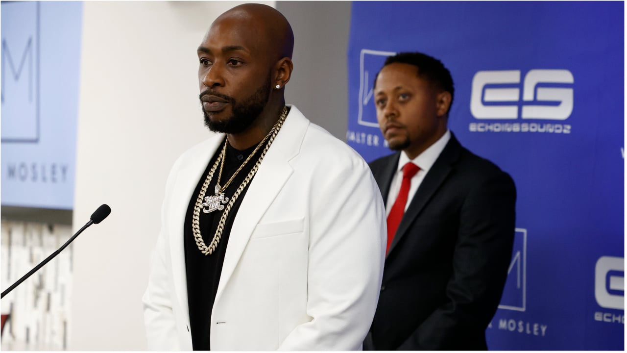 Ceaser Emanuel and his attorney Walter Mosley standing at a press conference