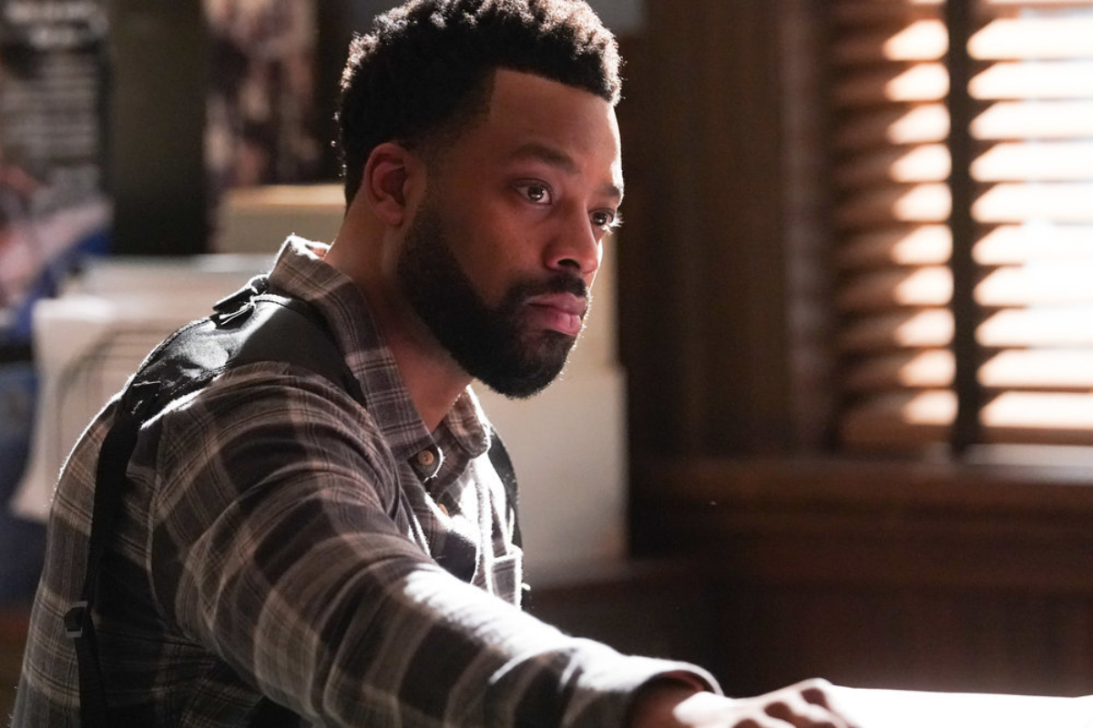 Atwater's new love interest Celeste was introduced in Chicago P.D. Season 9. Atwater wears a flannel and sits at a desk. 