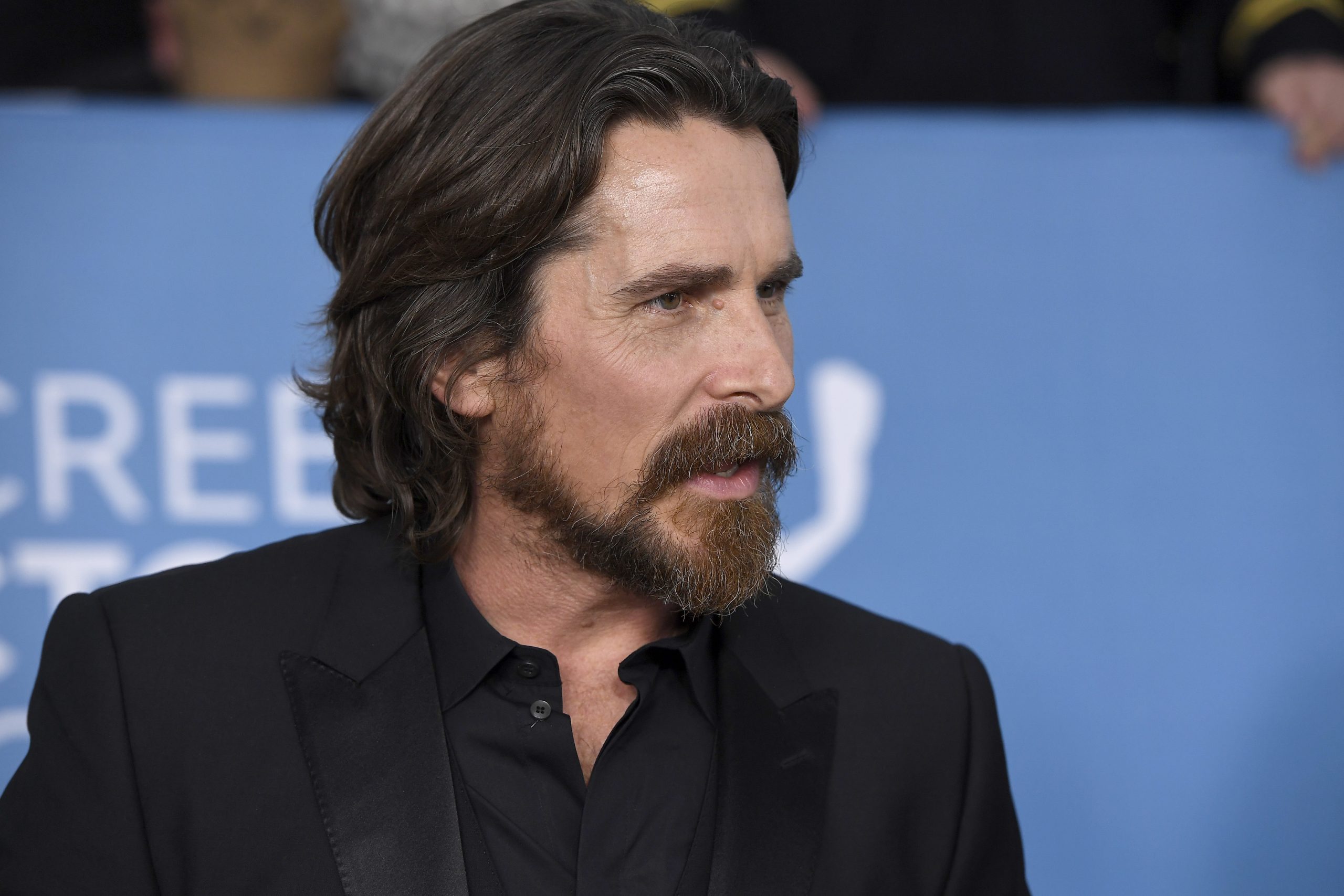 Christian Bale, who stars as Gorr the God Butcher in 'Thor: Love and Thunder,' wears a black suit