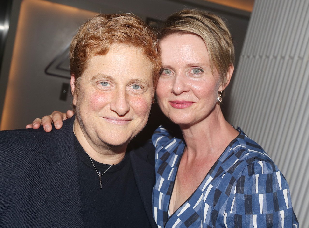 Christine Marinoni and wife Cynthia Nixon pose together cheek to cheek.