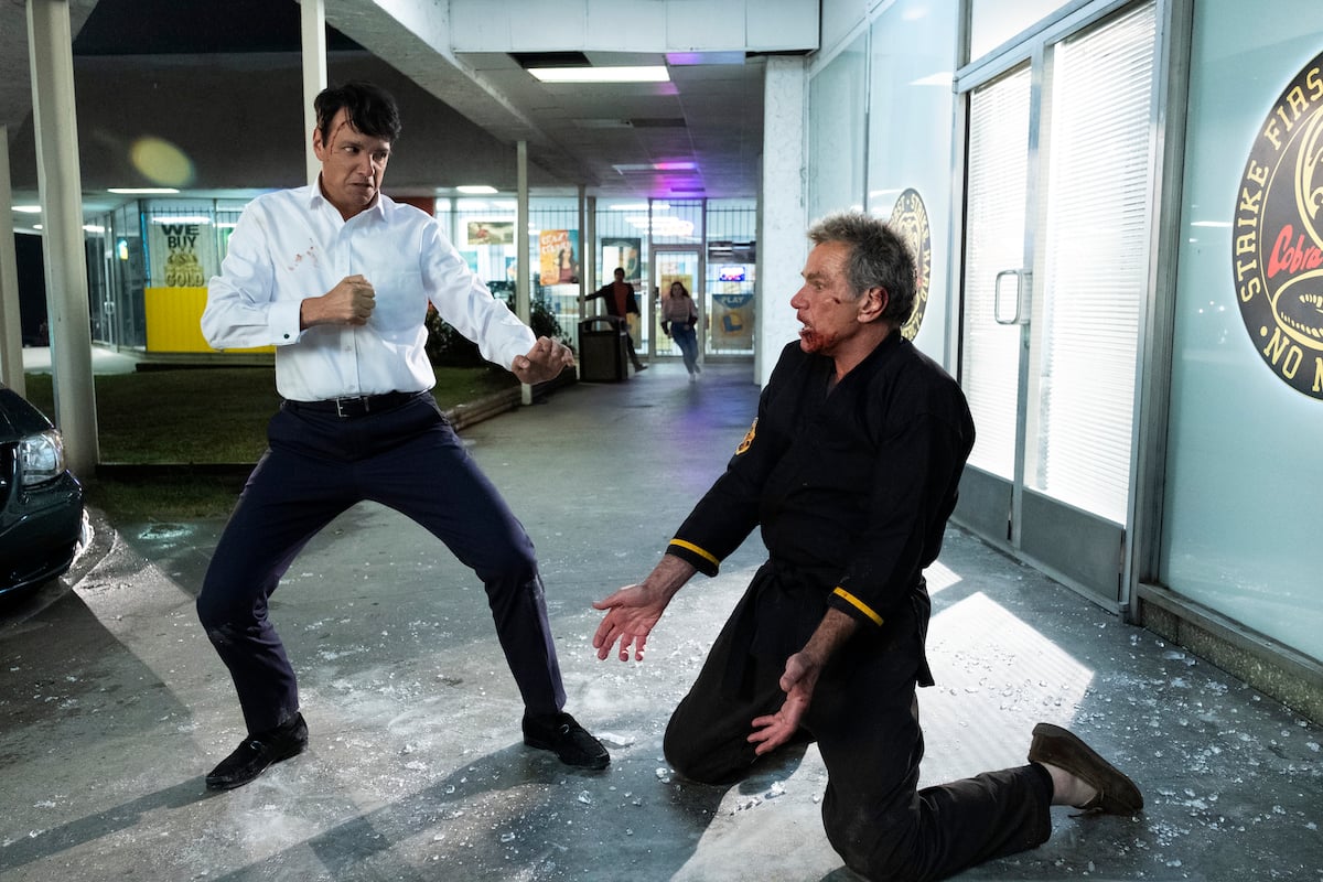 'Cobra Kai': John Kreese (Martin Kove) kneels on the sidewalk in front of Daniel LaRusso (Ralph Macchio)