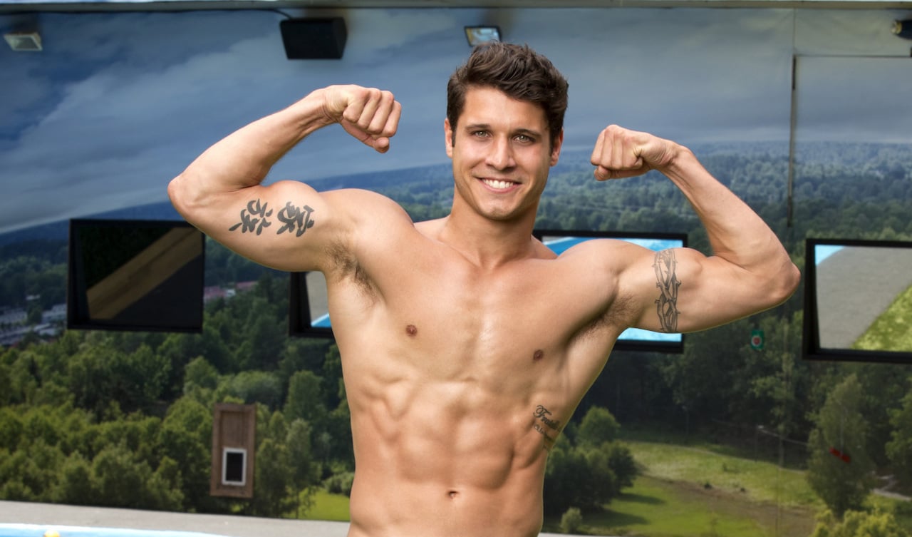 Cody Calafiore of 'Big Brother 16' poses shirtless while flexing his biceps.