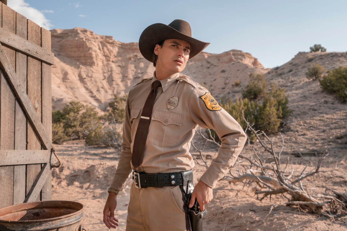 Kiowa Gordon will make his debut as Jim Chee in Dark Winds series premiere. Jim wears a Tribal Police uniform and cowboy hat. 