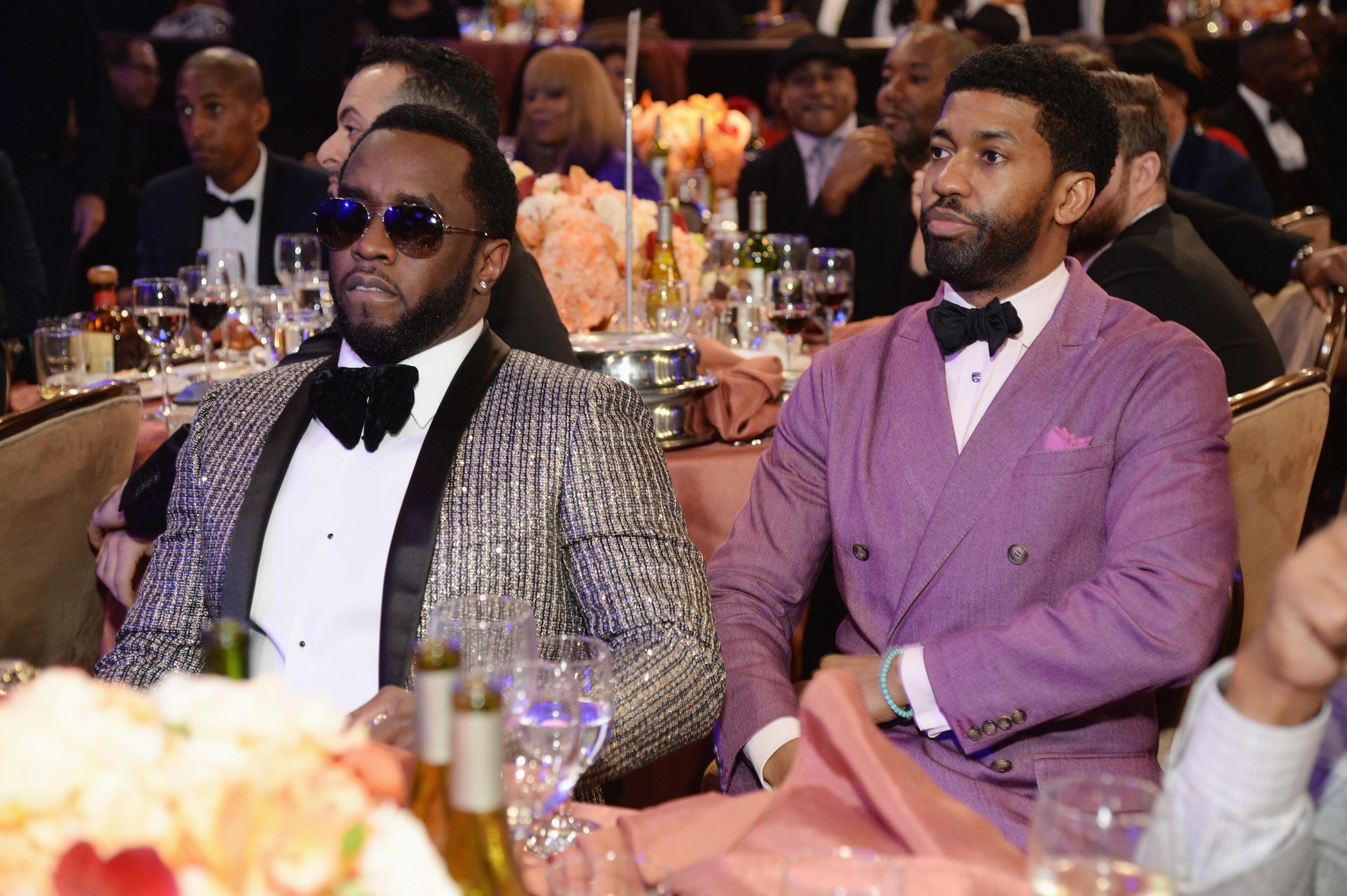 Diddy and his assistant Fonzworth Bentley sitting together at an event