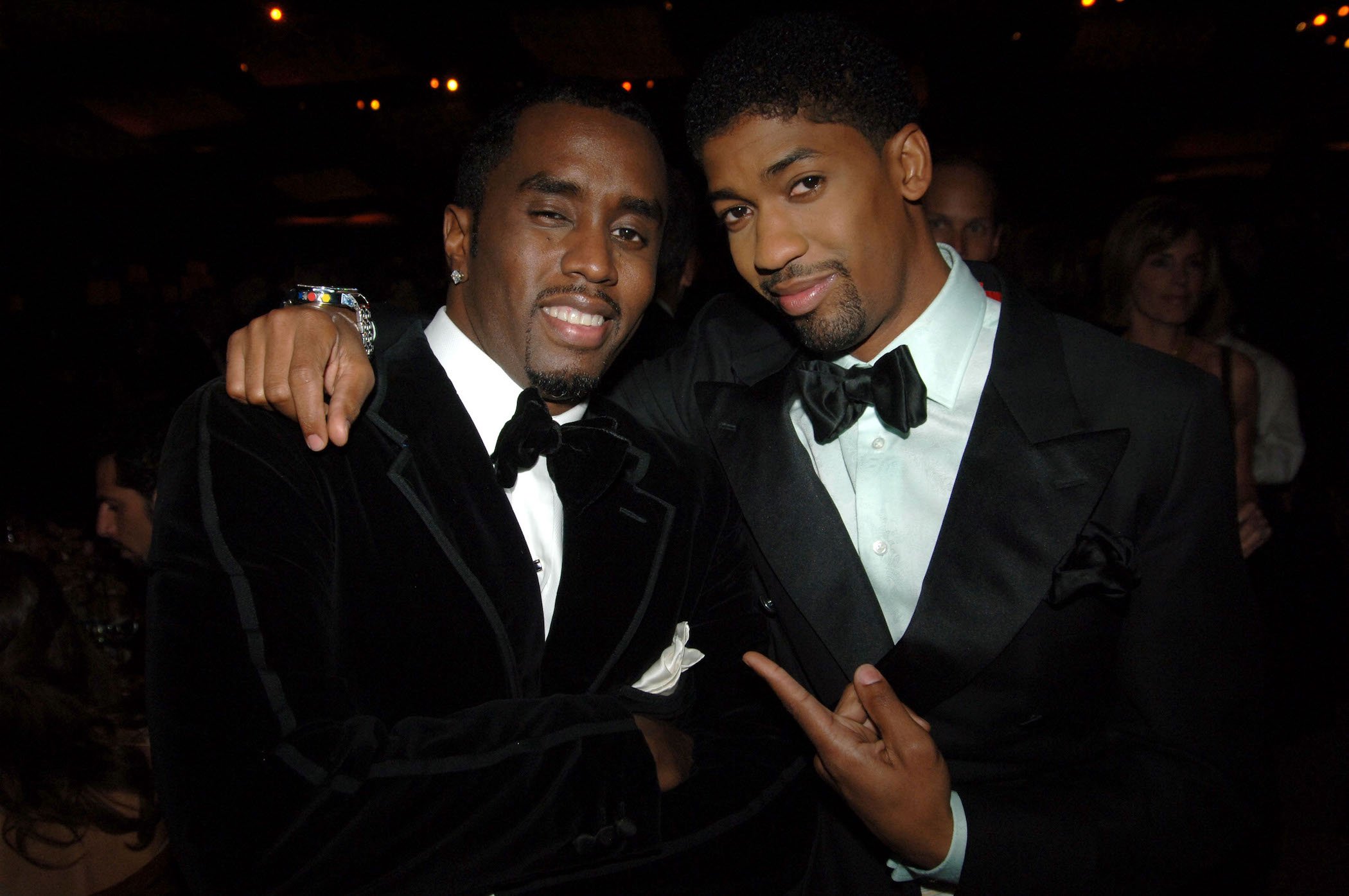 Diddy and his assistant Derek Watkins aka Fonzworth Bentley in suits at an event