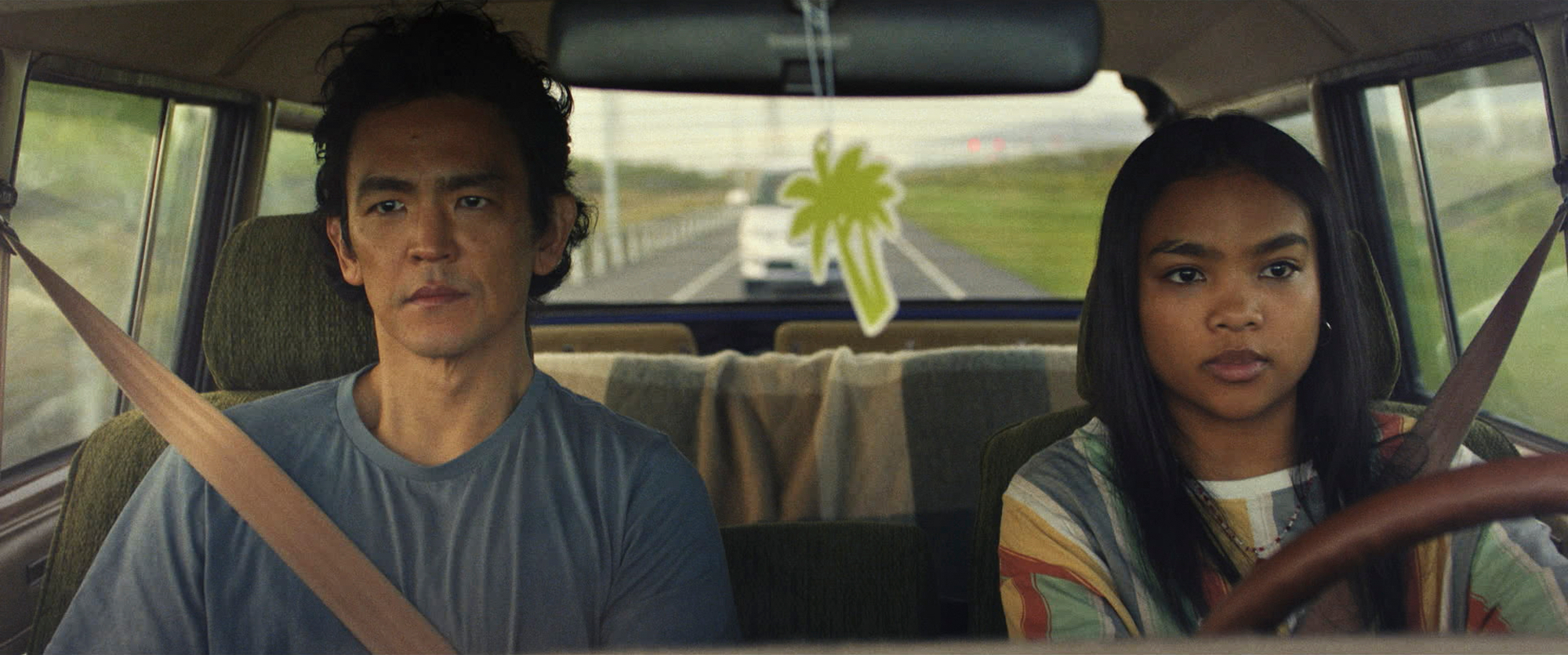 'Don't Make Me Go' John Cho as Max Park and Mia Isaac as Wally Park looking straight ahead in a car wearing their seatbelts