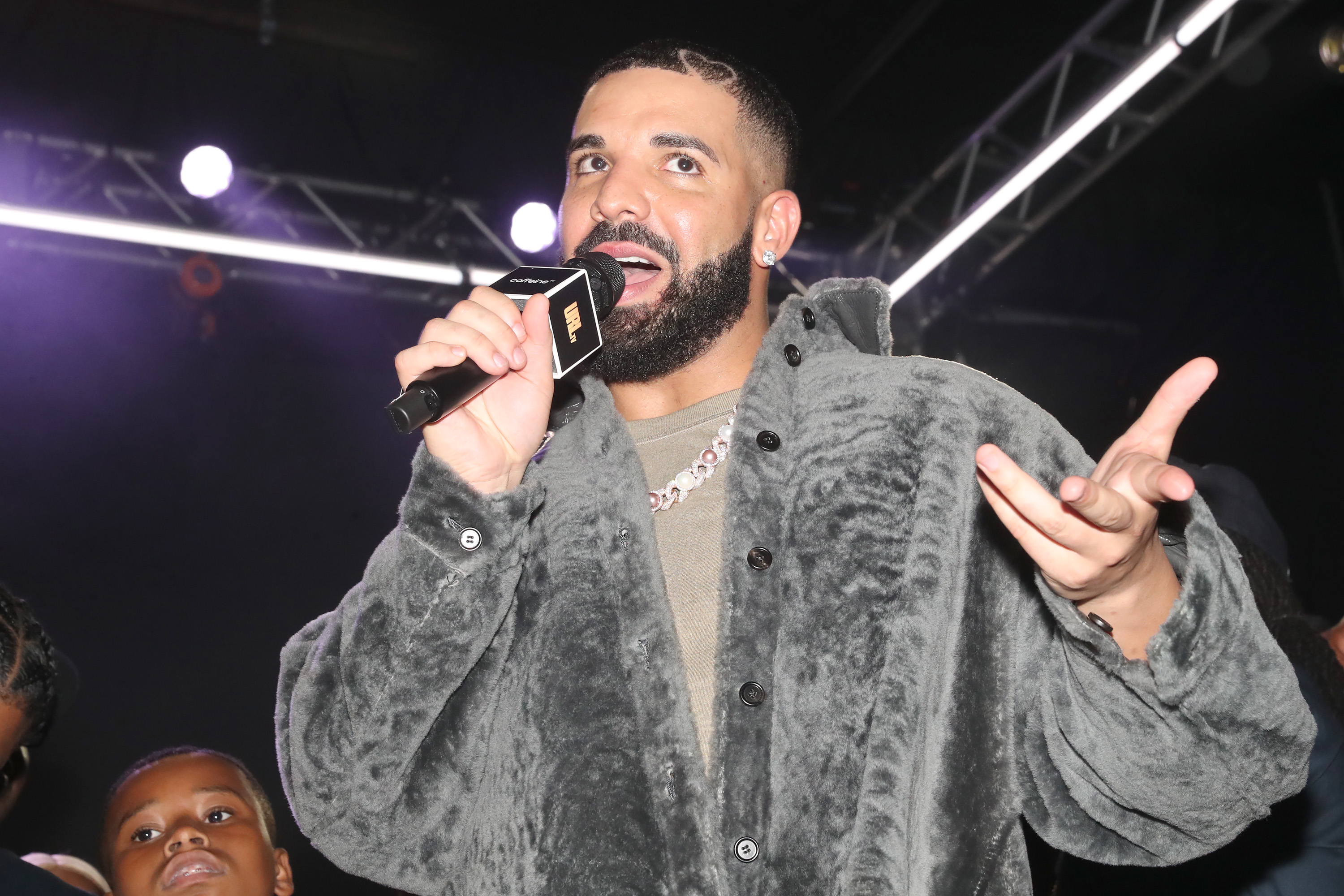 Drake, who just dropped 'Honestly, Nevermind,' speaks into a microphone. 