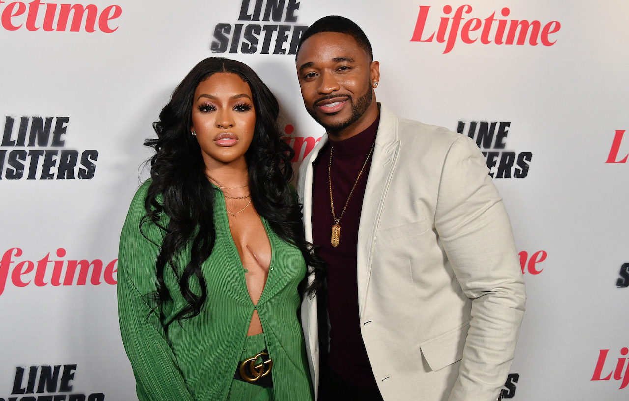 Drew Sidora and husband Ralph Pittman pose on red carpet; Sidora teased a new single about her marital trouble