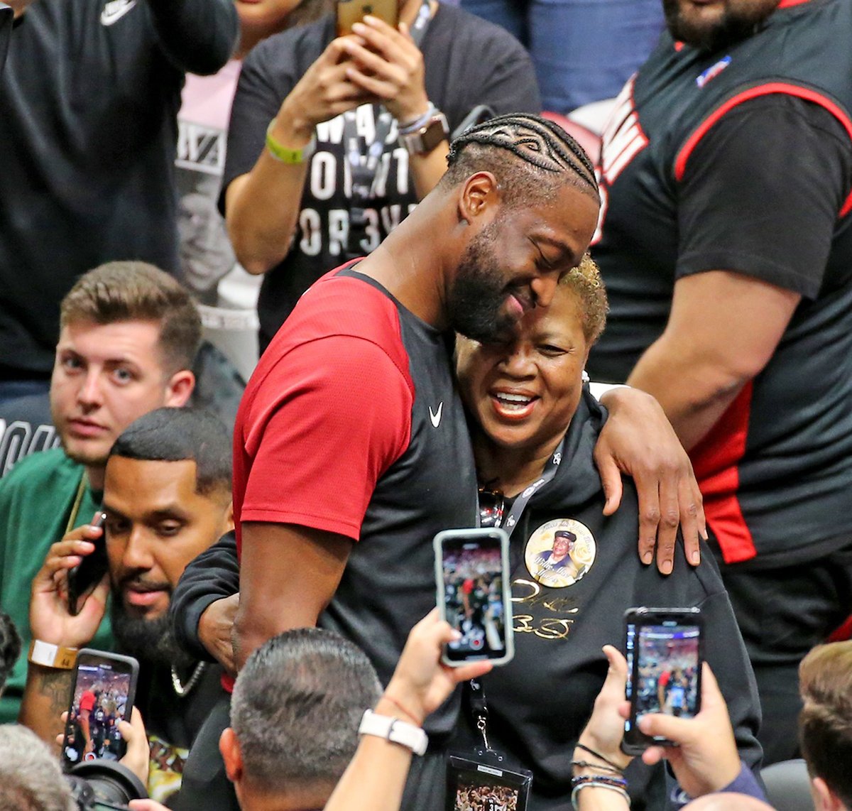 The Miami Heat's Dwyane Wade hugs his mom, Jolinda, before a 2019 game