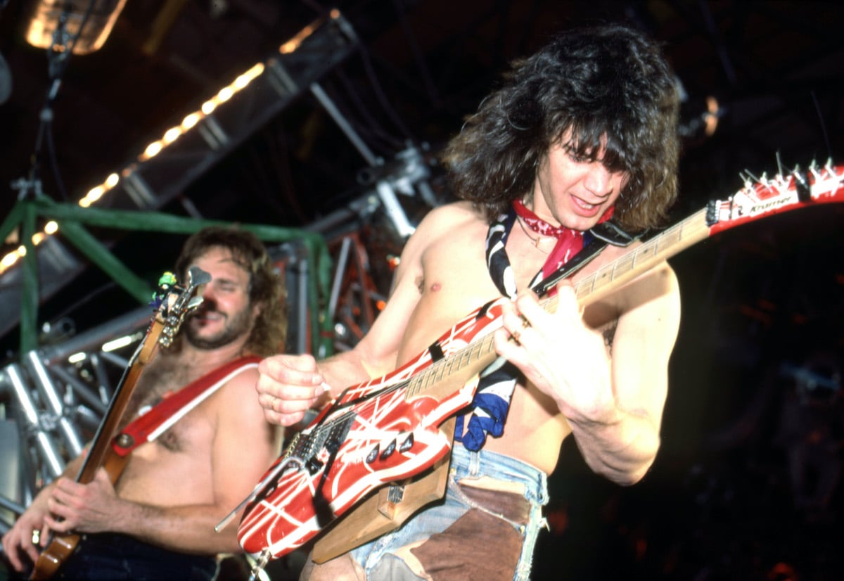 Eddie Van Halen playing guitar on stage at a 1984 concert in Detroit
