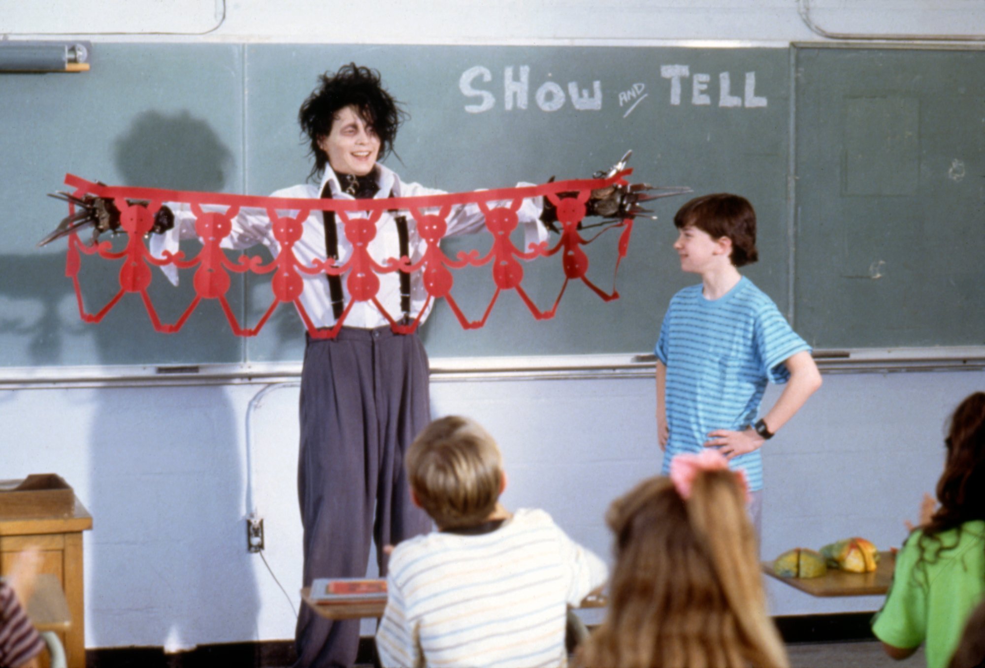 'Edward Scissorhands' Johnny Depp as Edward Scissorhands holding up paper people in front of classroom