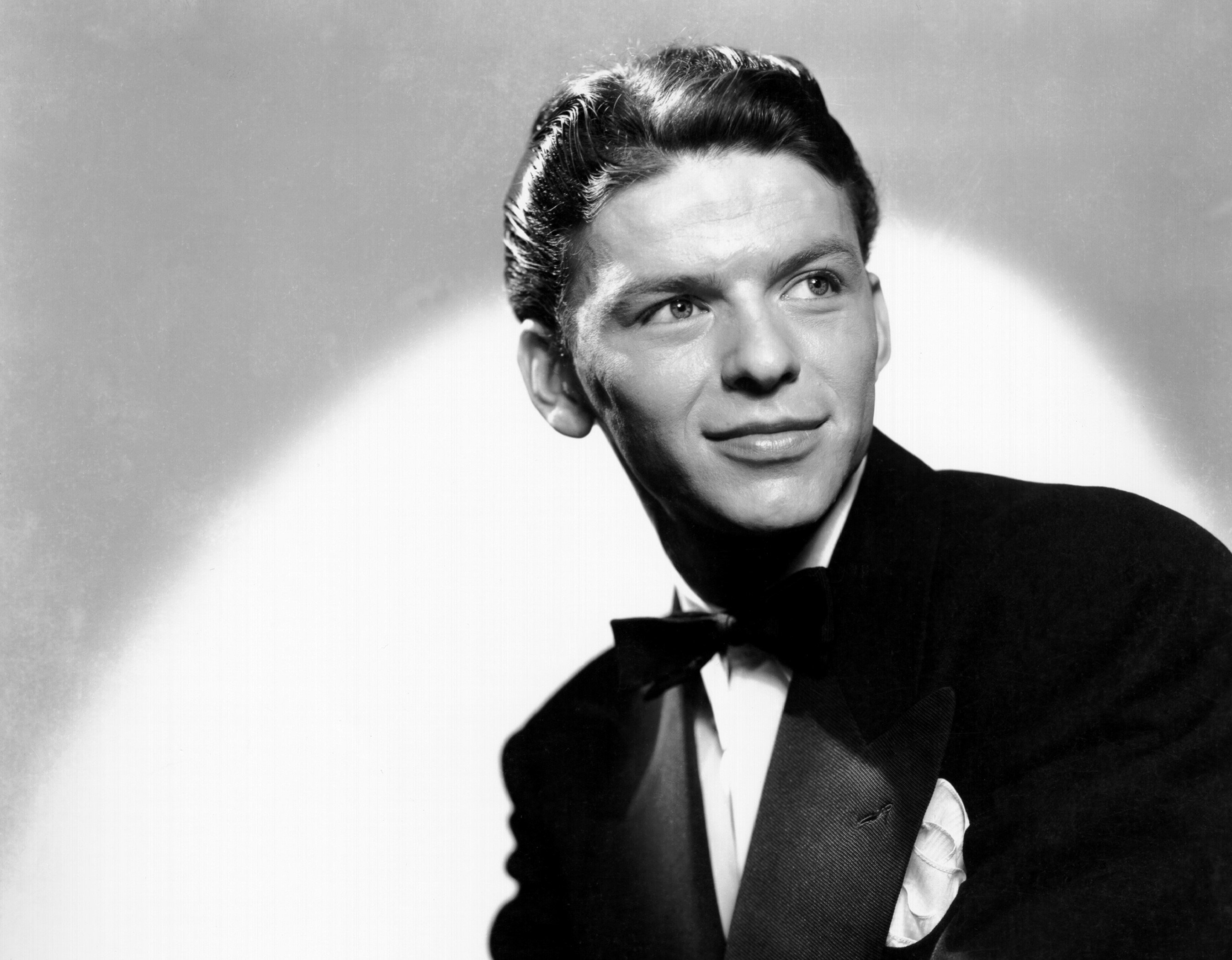 A black and white picture of Frank Sinatra wearing a tuxedo.