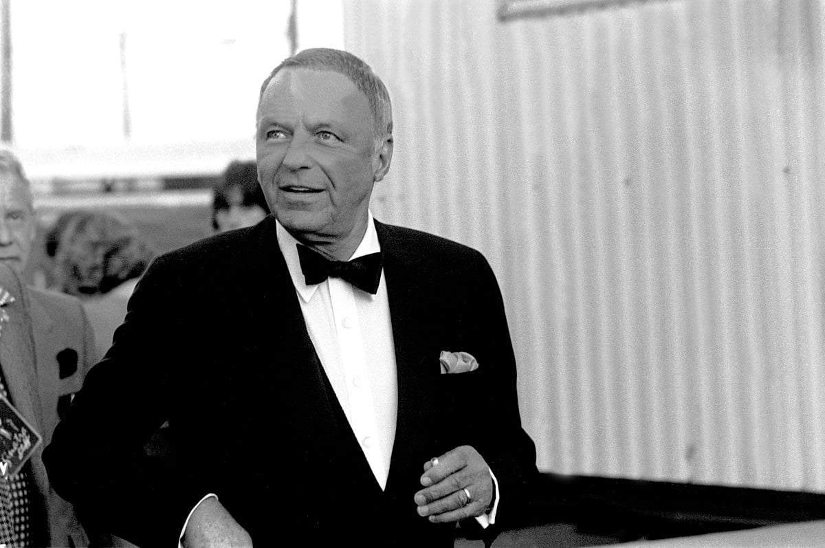 Frank Sinatra smiling while wearing a suit.
