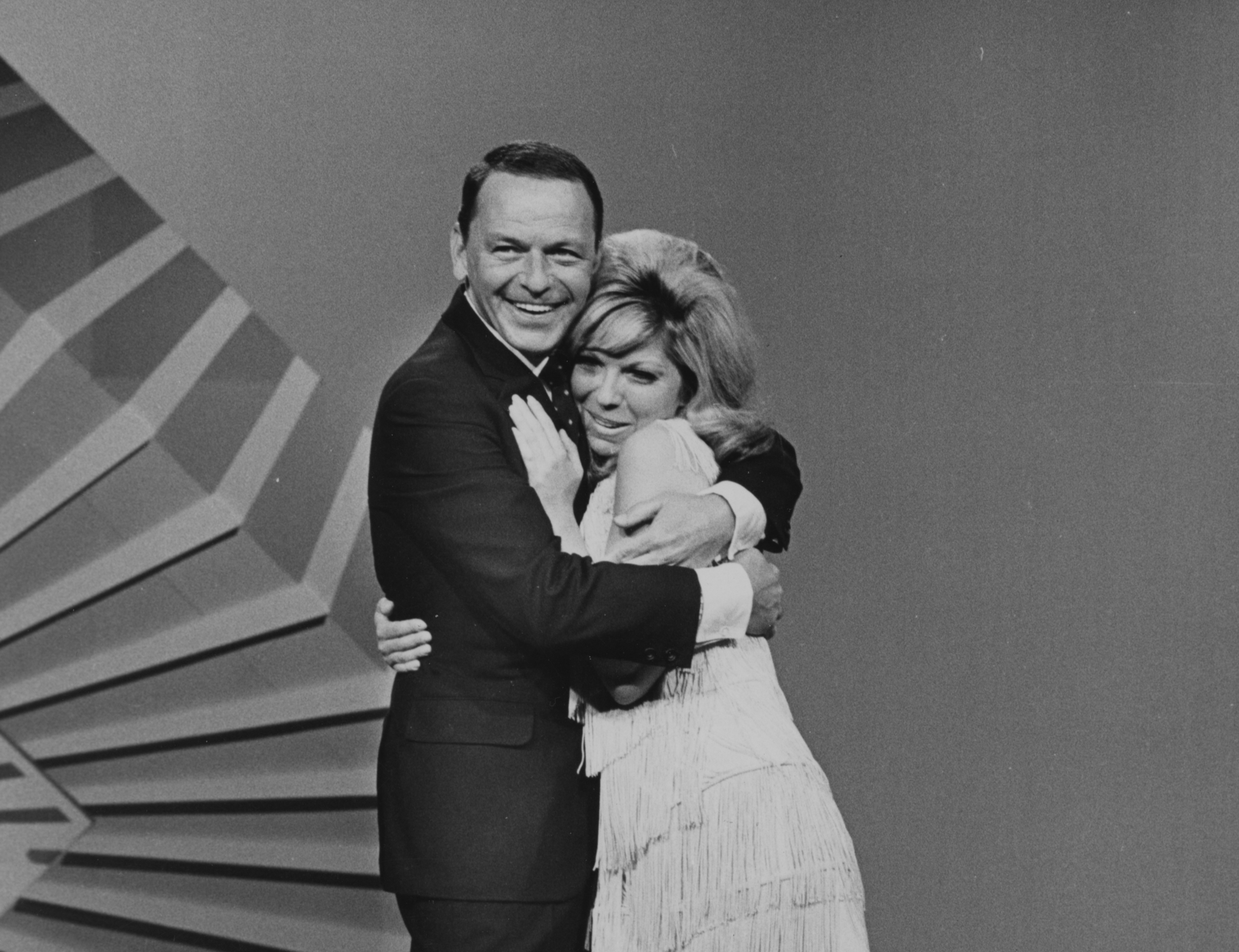 Frank Sinatra and his daughter Nancy Sinatra embrace.