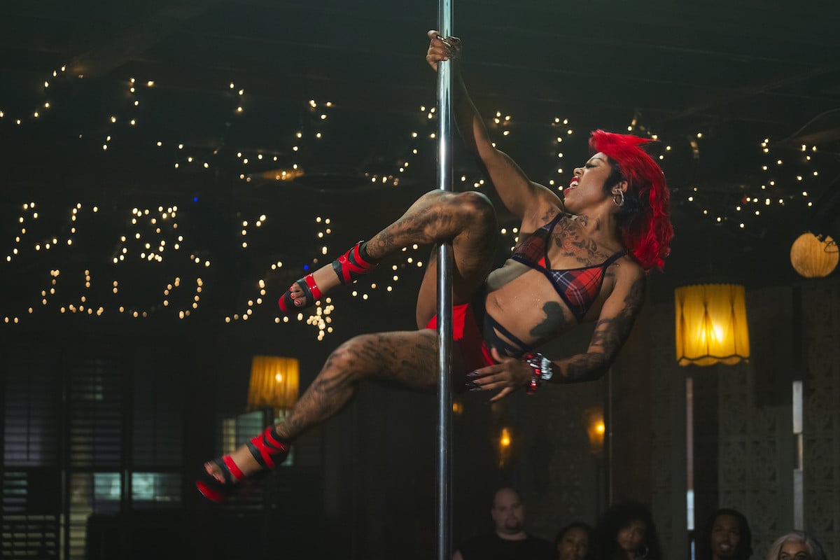 Gail Bean as Roulette wearing black and red while performing a dance stunt in 'P-Valley'