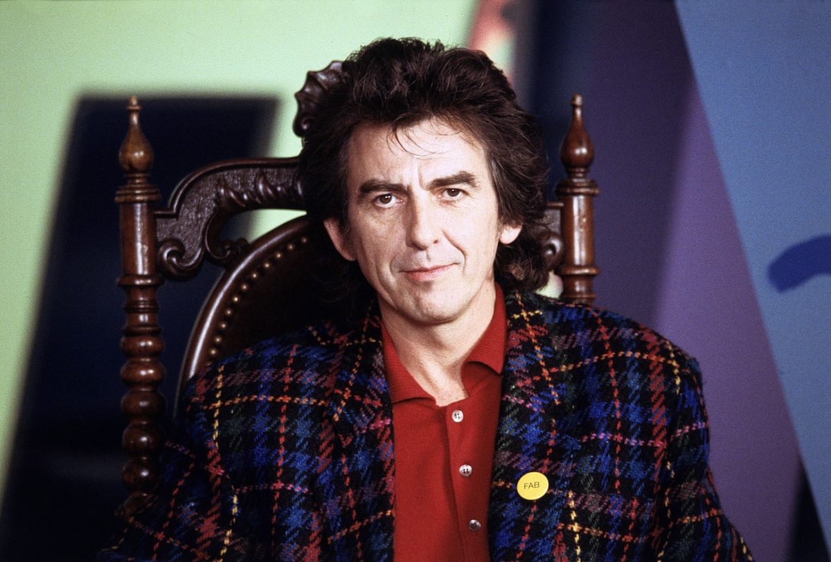 George Harrison posing in a multicolored suit in 1988.