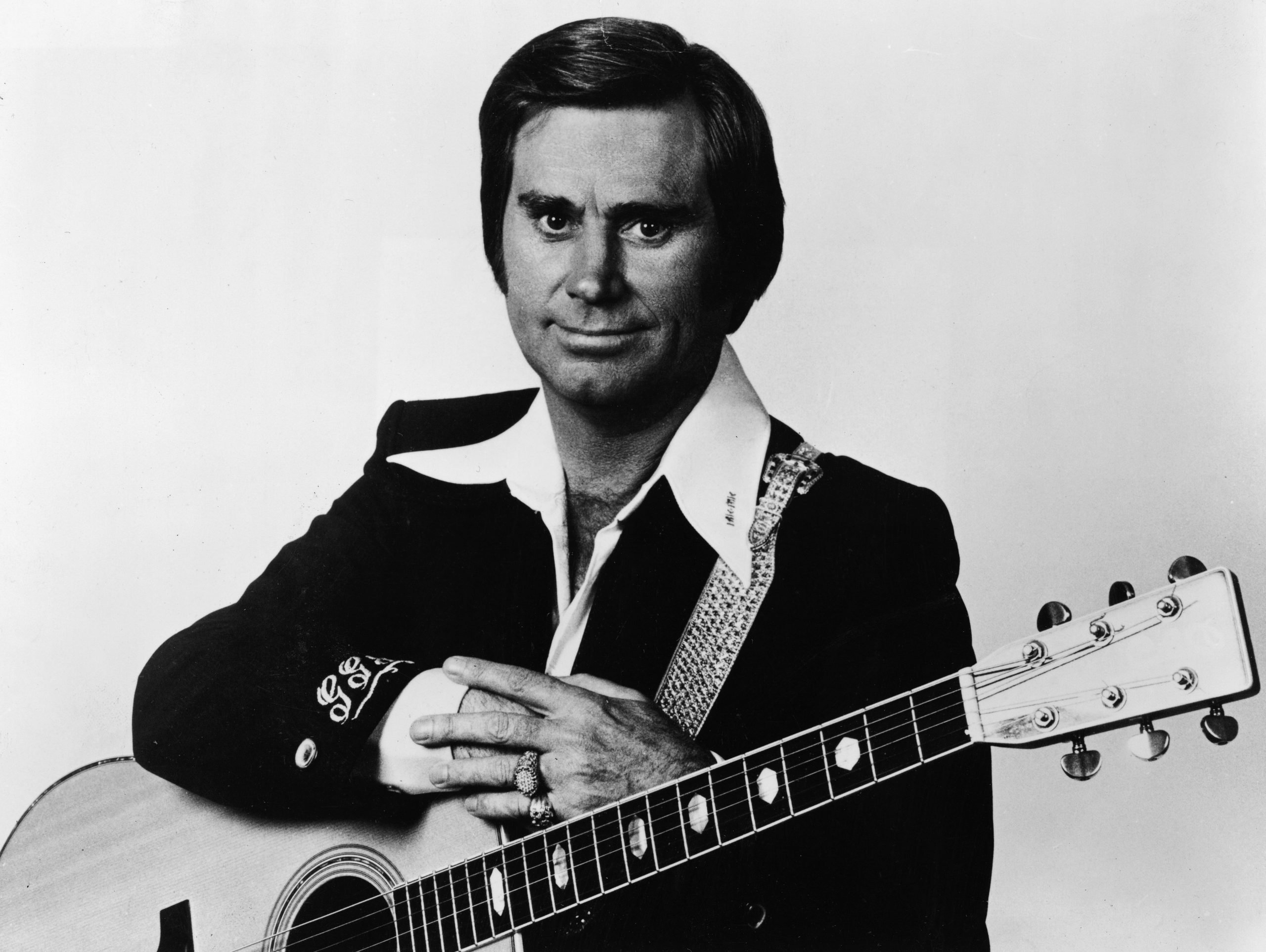 George Jones, who once rode a lawnmower to a liquor store, pictured with an acoustic guitar, circa 1970.