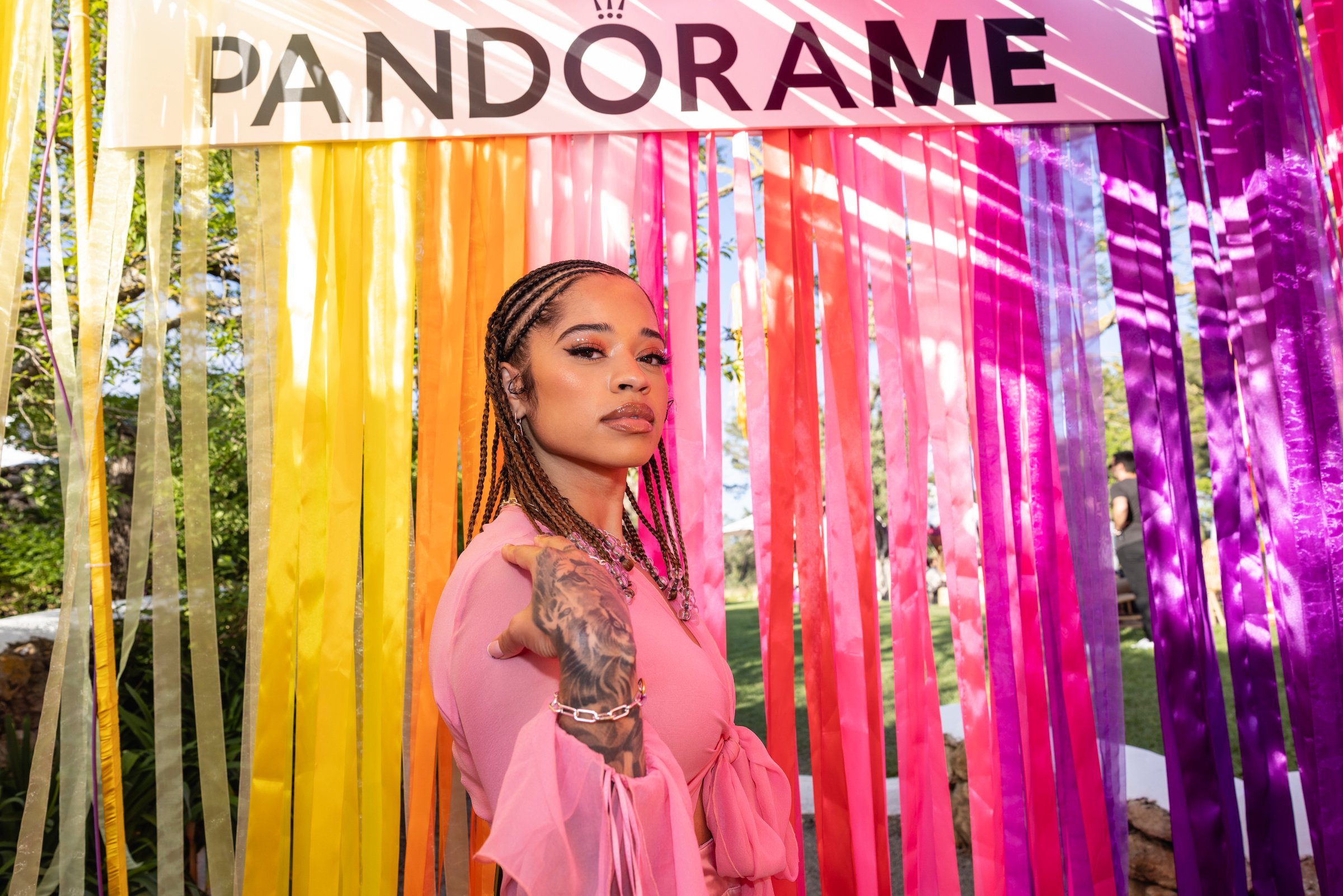 Ella Mai, who has been mentored by Mary J. Blige, on a rainbow background