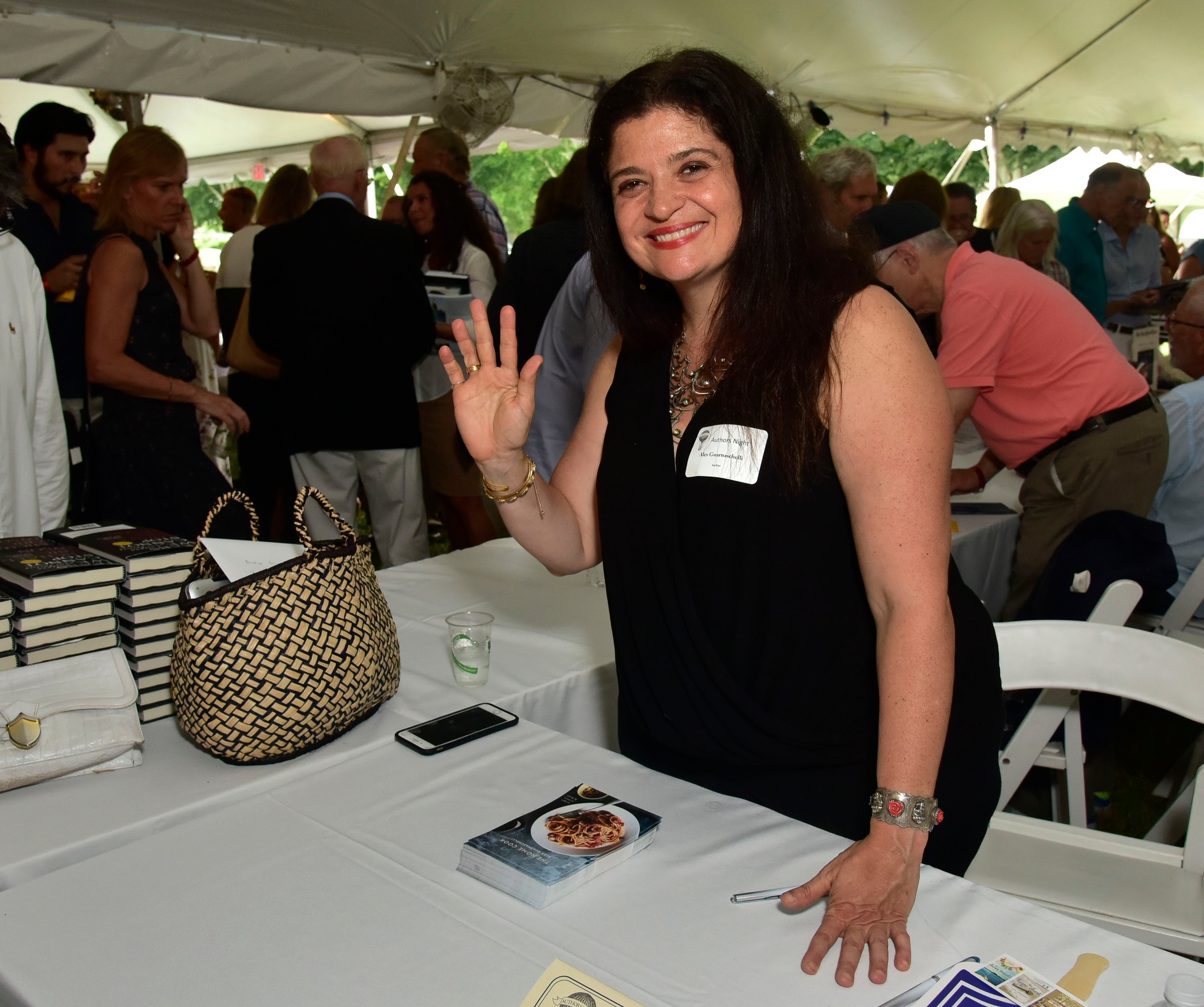 Alex Guarnaschelli wears a sleeveless black blouse in this photograph.