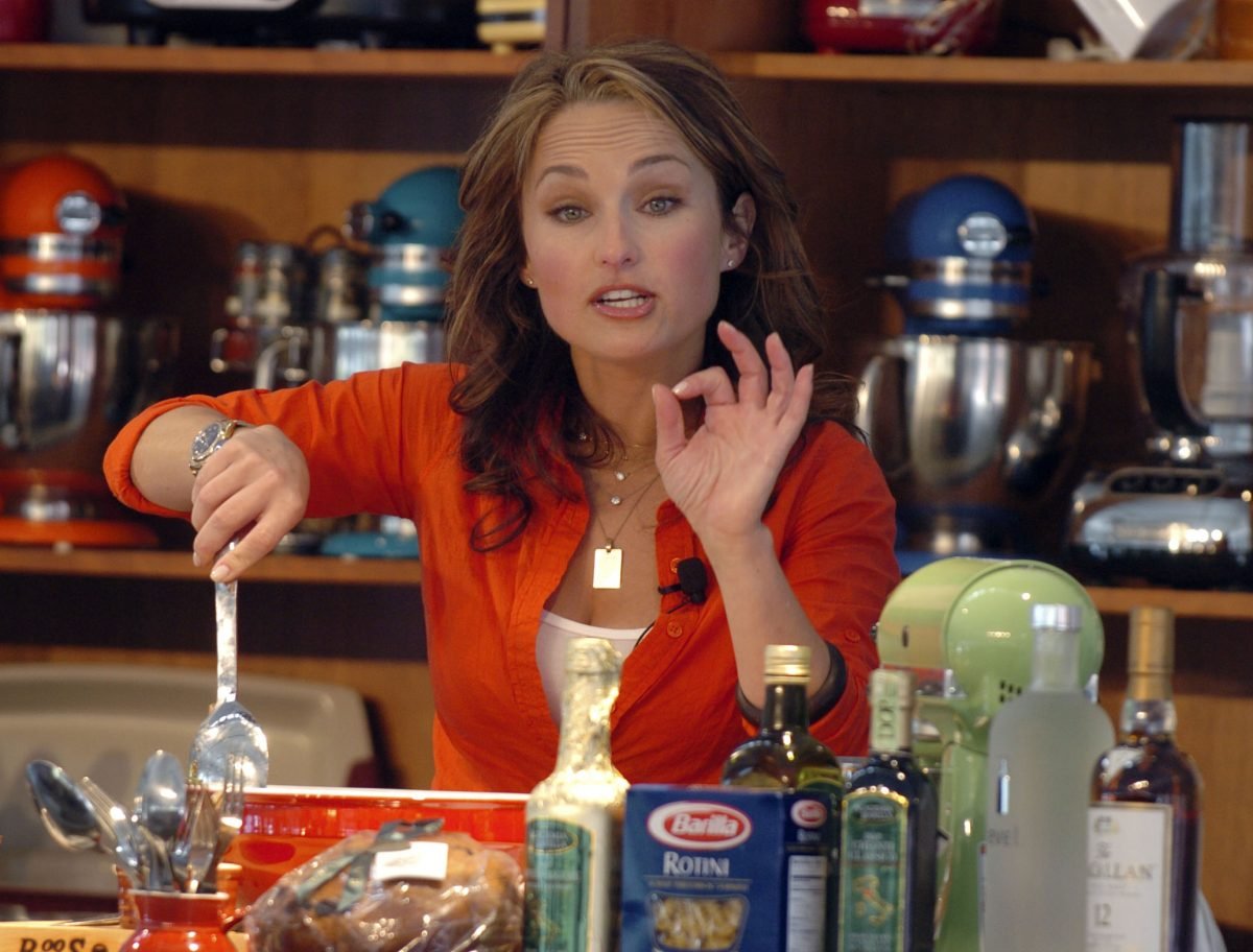 Celebrity chef Giada De Laurentiis wears an orange blouse in this photograph.