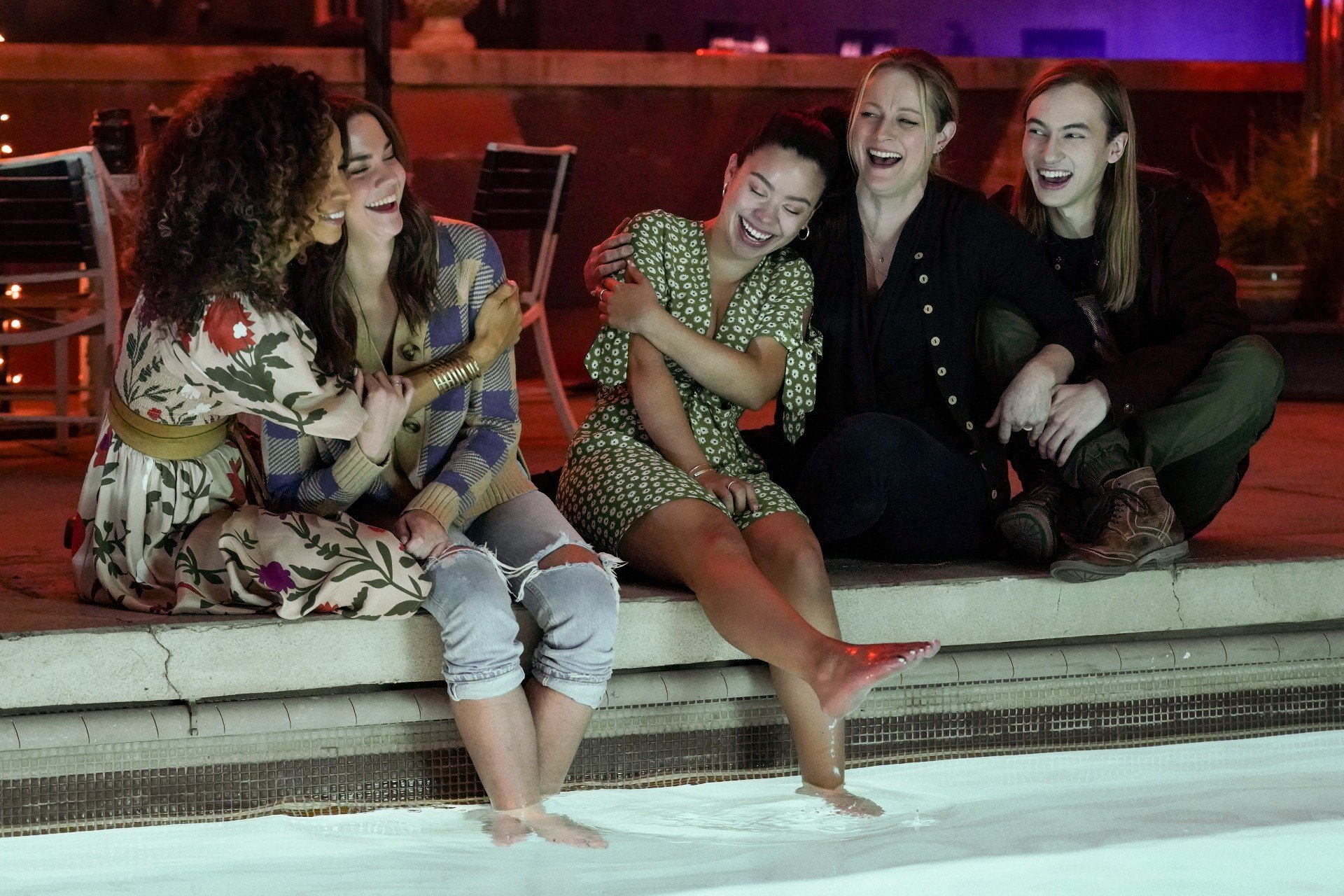 The Good Trouble cast laughs at the pool.