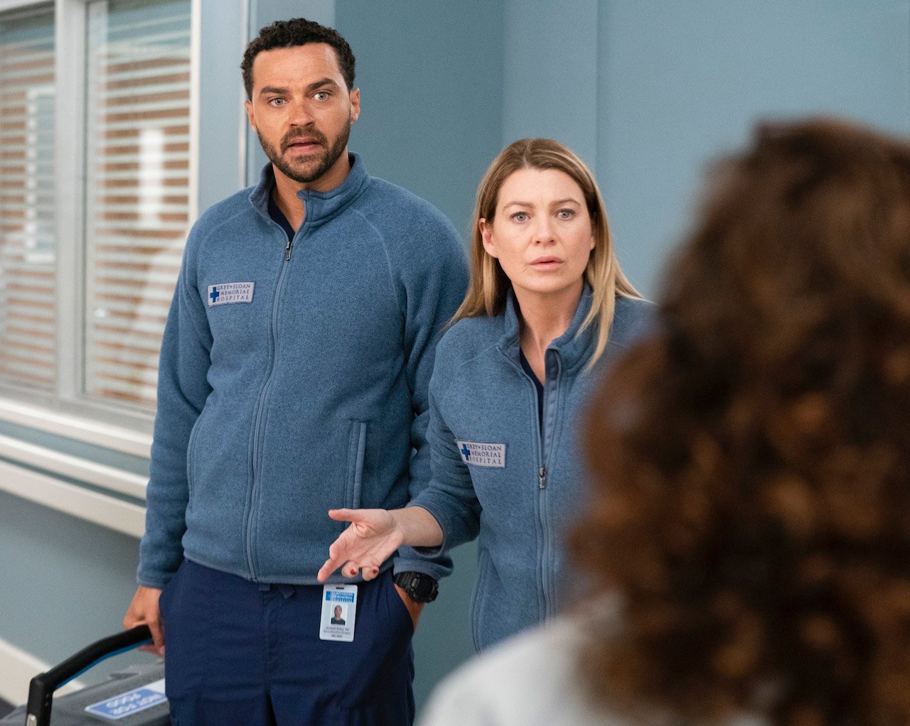 Jesse Williams as Jackson Avery and Ellen Pompeo as Meredith Grey stand next to each other in the hospital on 'Grey's Anatomy'.
