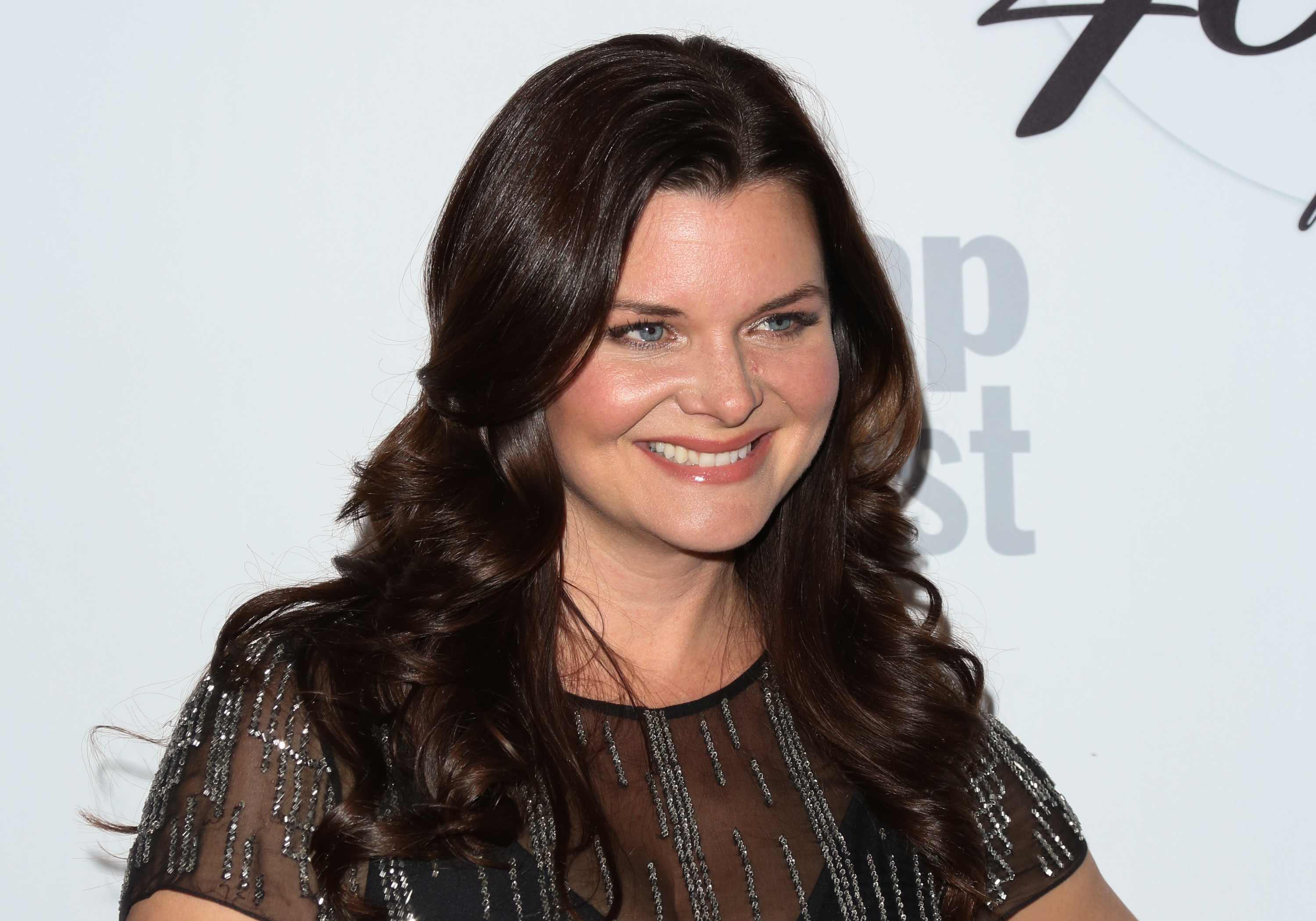 'The Bold and the Beautiful' actor Heather Tom wearing a black sequined dress during a red carpet appearance.